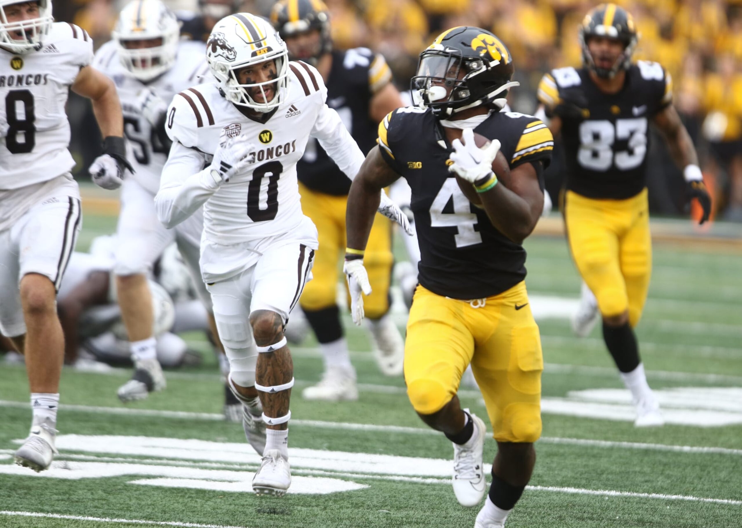 IOWA CITY, IOWA- SEPTEMBER 16:  Running back Leshon Williams #4 of the Iowa Hawkeyes runs down the field during the first half in front of cornerback DaShon Bussell #0 of the Western Michigan Broncos at Kinnick Stadium on September 16, 2023 in Iowa City, Iowa.  (Photo by Matthew Holst/Getty Images)