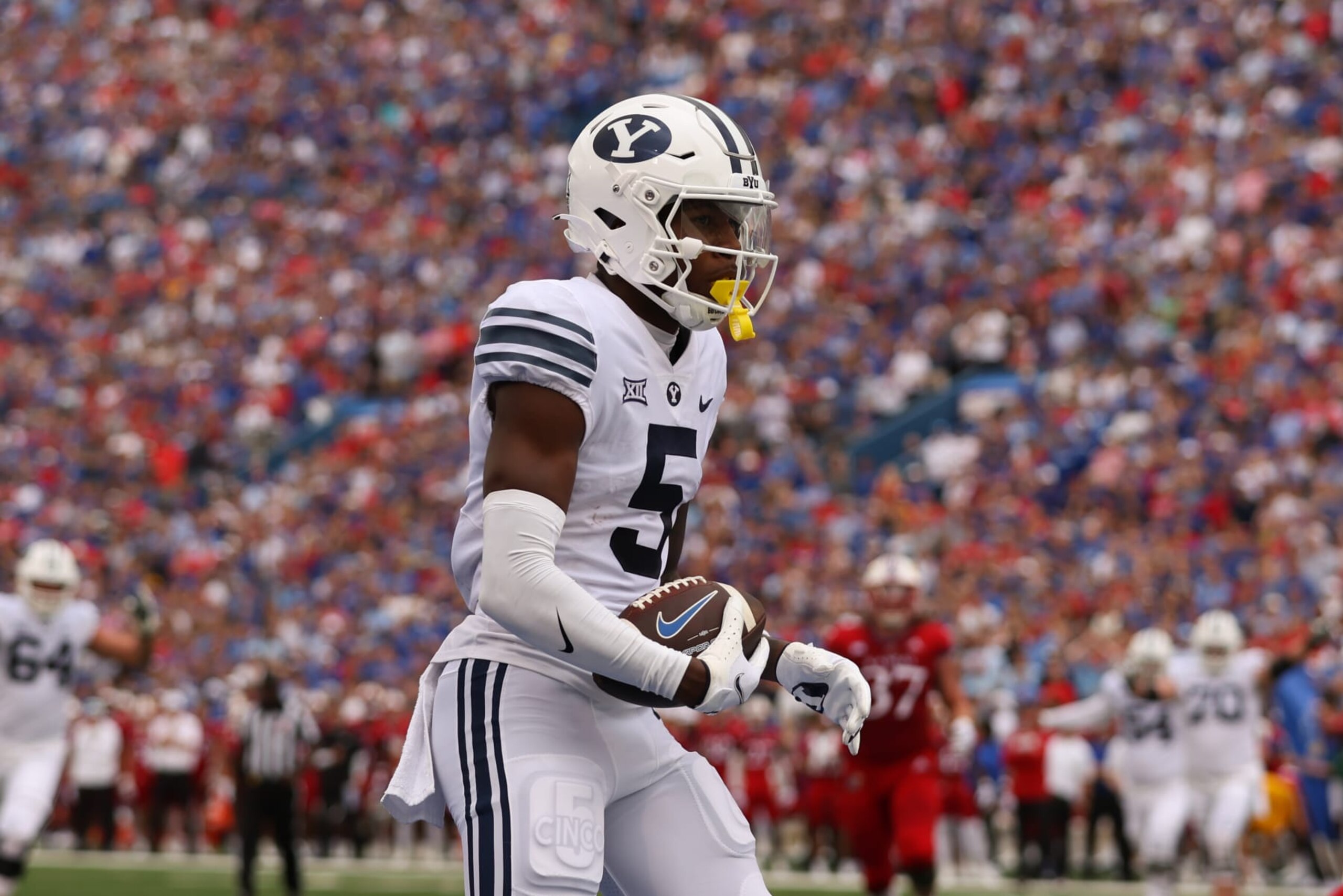 LAWRENCE, KS - SEPTEMBER 23: Brigham Young Cougars wide receiver Darius Lassiter (5) after a 7-yard touchdown reception in the first quarter of a Big 12 football game between the Brigham Young Cougars and Kansas Jayhawks on Sep 23, 2023 at David Booth Memorial Stadium in Lawrence, KS. (Photo by Scott Winters/Icon Sportswire via Getty Images)
