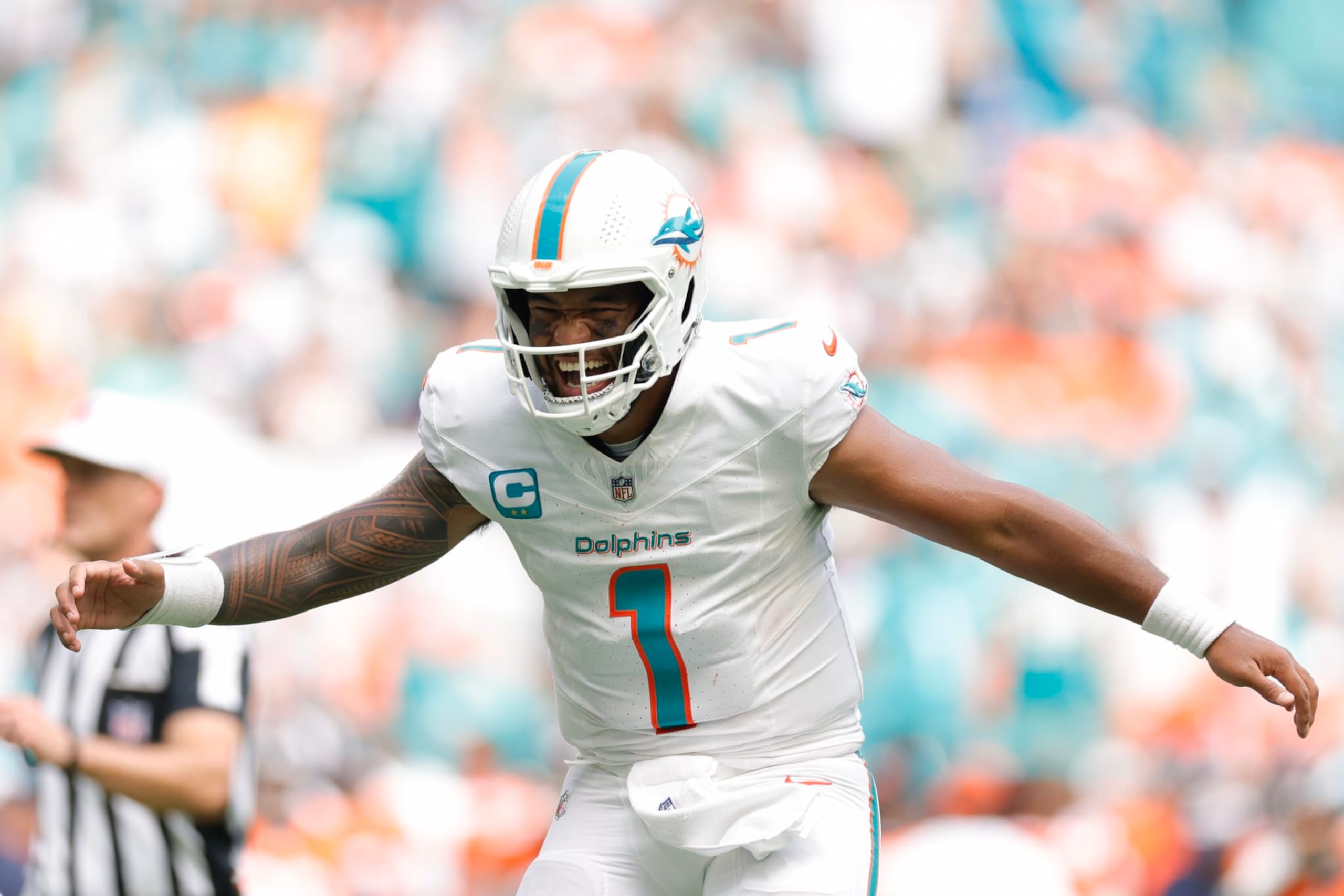MIAMI GARDENS, FLORIDA - SEPTEMBER 24: Tua Tagovailoa #1 of the Miami Dolphins celebrates a Miami rushing touchdown during the third quarter against the Denver Broncos at Hard Rock Stadium on September 24, 2023 in Miami Gardens, Florida. (Photo by Carmen Mandato/Getty Images) MIAMI GARDENS, FLORIDA - SEPTEMBER 24: Tua Tagovailoa #1 of the Miami Dolphins celebrates a Miami rushing touchdown during the third quarter against the Denver Broncos at Hard Rock Stadium on September 24, 2023 in Miami Gardens, Florida. (Photo by Carmen Mandato/Getty Images)
