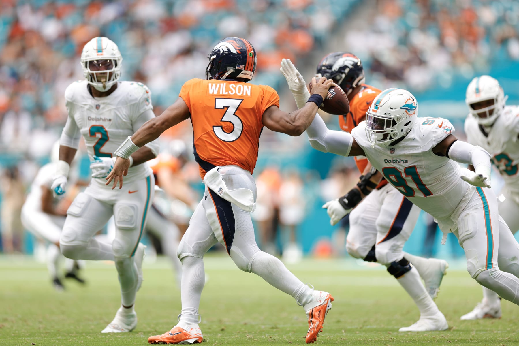 MIAMI GARDENS, FLORIDA - SEPTEMBER 24: Emmanuel Ogbah #91 of the Miami Dolphins pressures Russell Wilson #3 of the Denver Broncos during the fourth quarter at Hard Rock Stadium on September 24, 2023 in Miami Gardens, Florida. (Photo by Carmen Mandato/Getty Images)