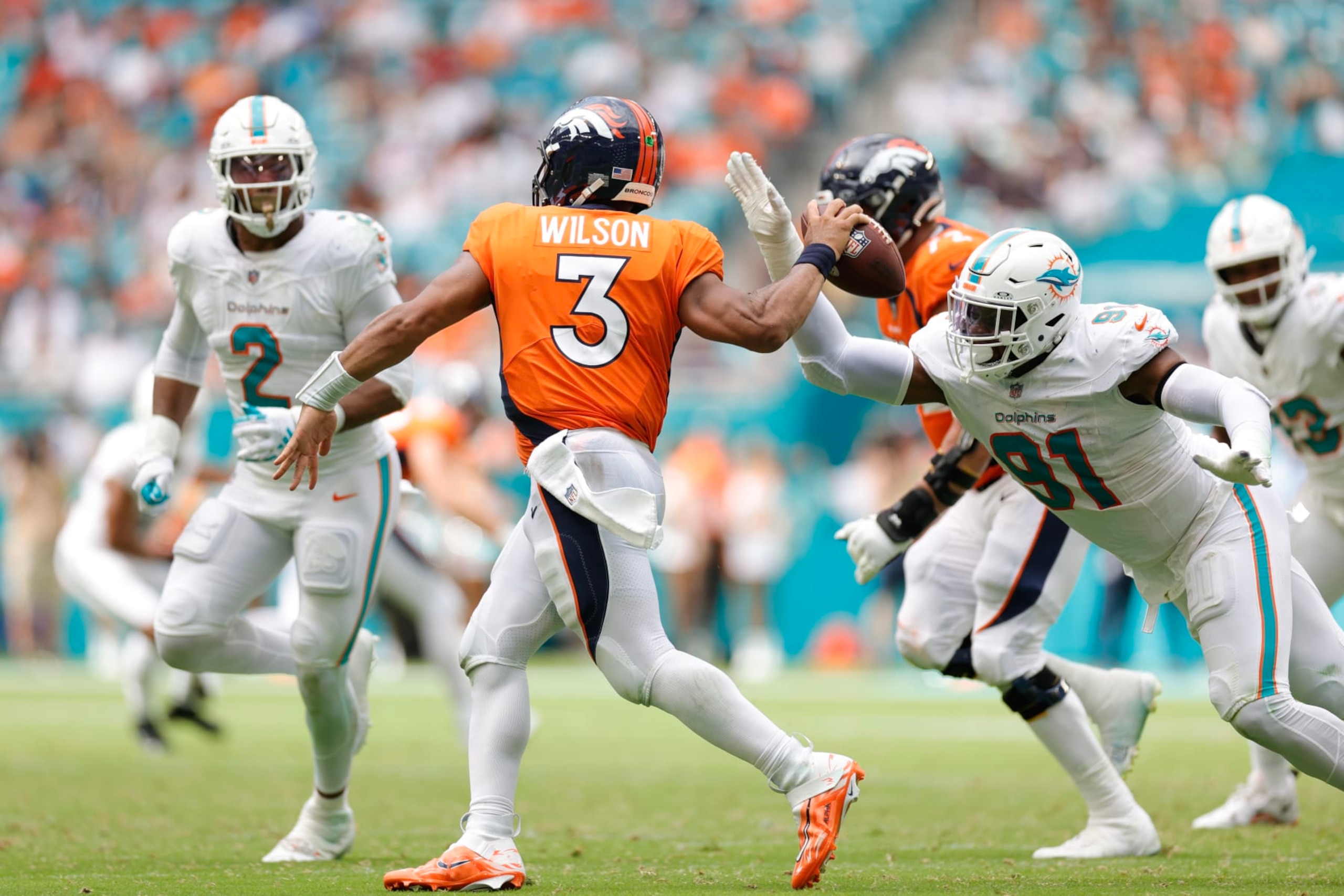 MIAMI GARDENS, FLORIDA - SEPTEMBER 24: Emmanuel Ogbah #91 of the Miami Dolphins pressures Russell Wilson #3 of the Denver Broncos during the fourth quarter at Hard Rock Stadium on September 24, 2023 in Miami Gardens, Florida. (Photo by Carmen Mandato/Getty Images) MIAMI GARDENS, FLORIDA - SEPTEMBER 24: Emmanuel Ogbah #91 of the Miami Dolphins pressures Russell Wilson #3 of the Denver Broncos during the fourth quarter at Hard Rock Stadium on September 24, 2023 in Miami Gardens, Florida. (Photo by Carmen Mandato/Getty Images)