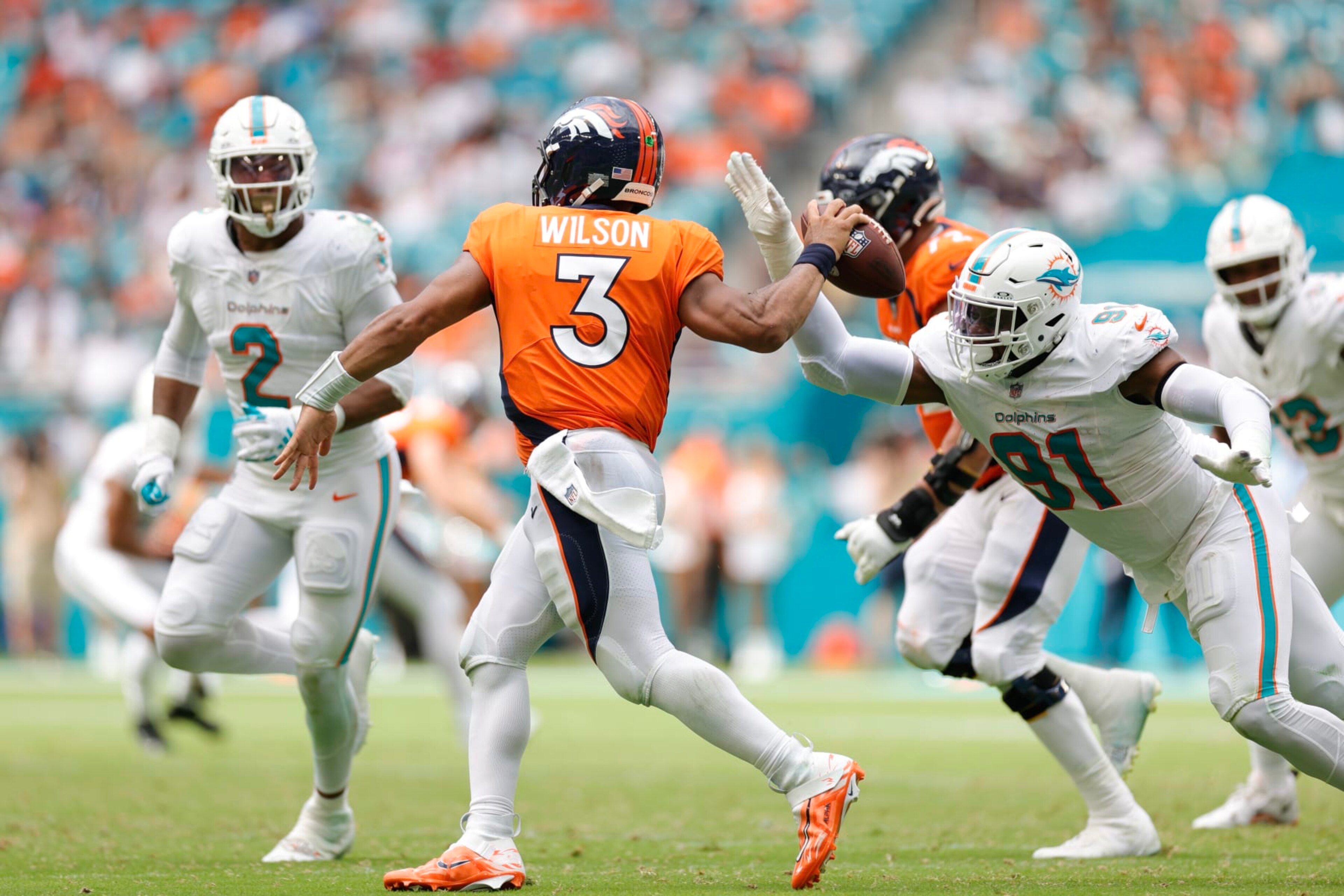 MIAMI GARDENS, FLORIDA - SEPTEMBER 24: Emmanuel Ogbah #91 of the Miami Dolphins pressures Russell Wilson #3 of the Denver Broncos during the fourth quarter at Hard Rock Stadium on September 24, 2023 in Miami Gardens, Florida. (Photo by Carmen Mandato/Getty Images)