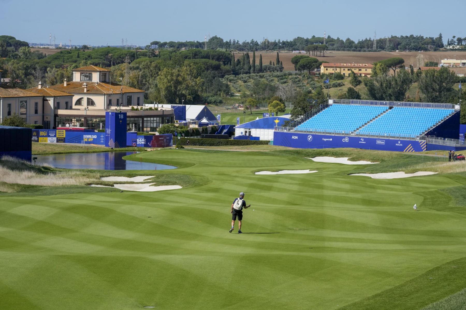 A workers tests the fairway of the 18th hole of the course of the Marco Simone Golf Club in Guidonia Montecelio, Monday, Sept. 25, 2023. The Marco Simone Club on the outskirts of Rome will host the 44th edition of The Ryder Cup, the biennial competition between Europe and the United States headed to Italy for the first time. (AP Photo/Andrew Medichini)