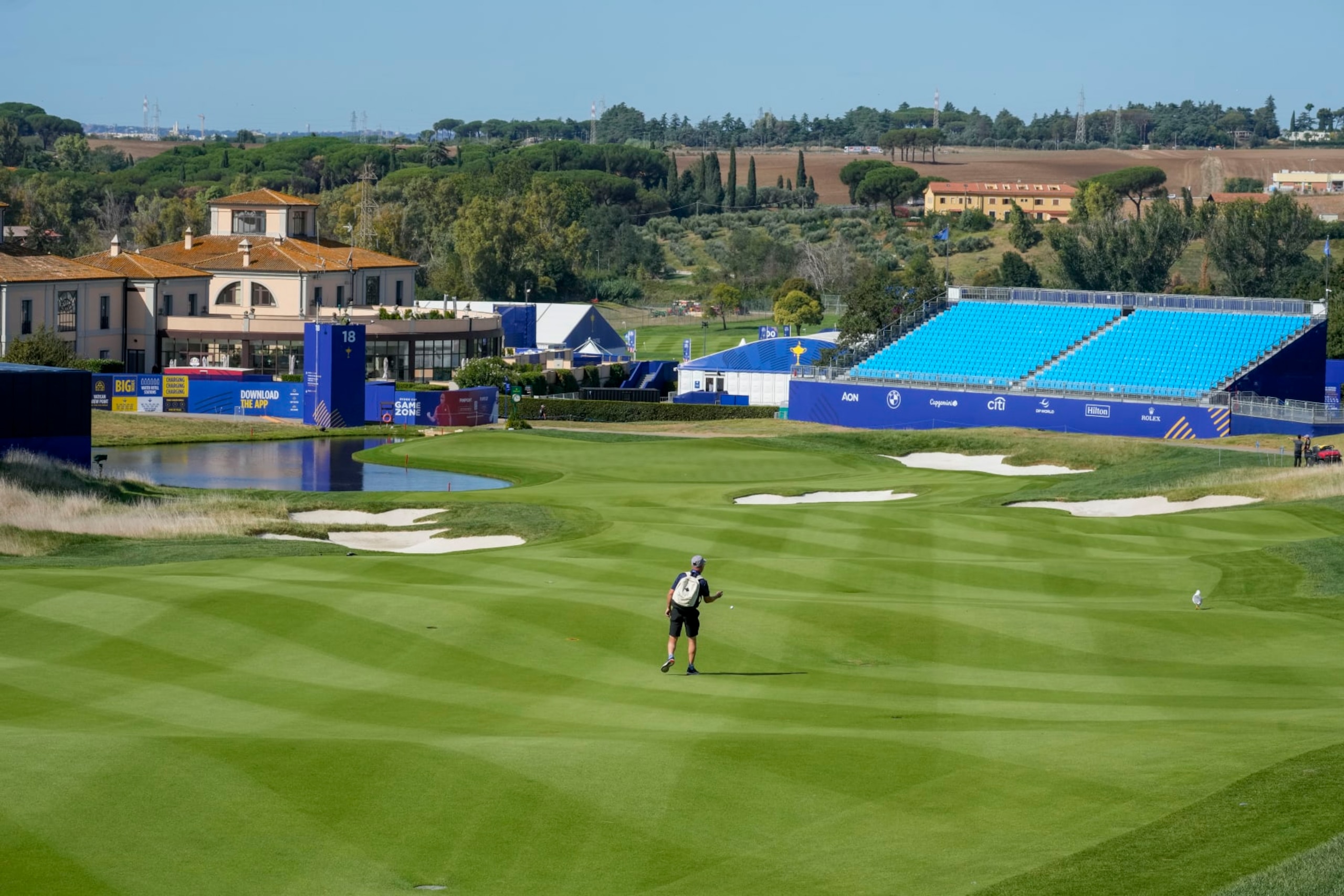 A workers tests the fairway of the 18th hole of the course of the Marco Simone Golf Club in Guidonia Montecelio, Monday, Sept. 25, 2023. The Marco Simone Club on the outskirts of Rome will host the 44th edition of The Ryder Cup, the biennial competition between Europe and the United States headed to Italy for the first time. (AP Photo/Andrew Medichini)