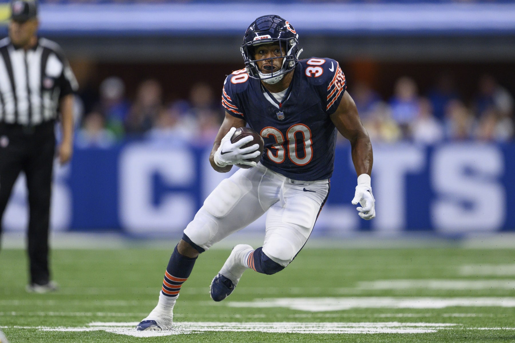 Chicago Bears running back Roschon Johnson (30) runs to the outside during an NFL football game against the Indianapolis Colts, Saturday, Aug. 19, 2023, in Indianapolis. (AP Photo/Zach Bolinger)