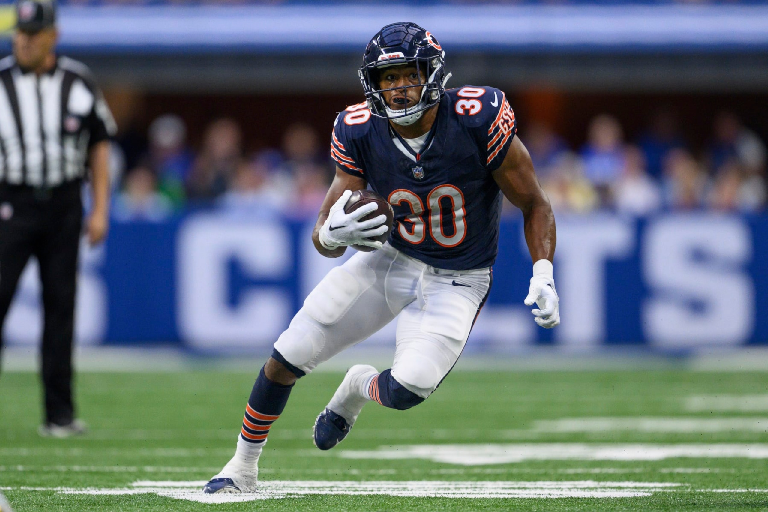 Chicago Bears running back Roschon Johnson (30) runs to the outside during an NFL football game against the Indianapolis Colts, Saturday, Aug. 19, 2023, in Indianapolis. (AP Photo/Zach Bolinger)