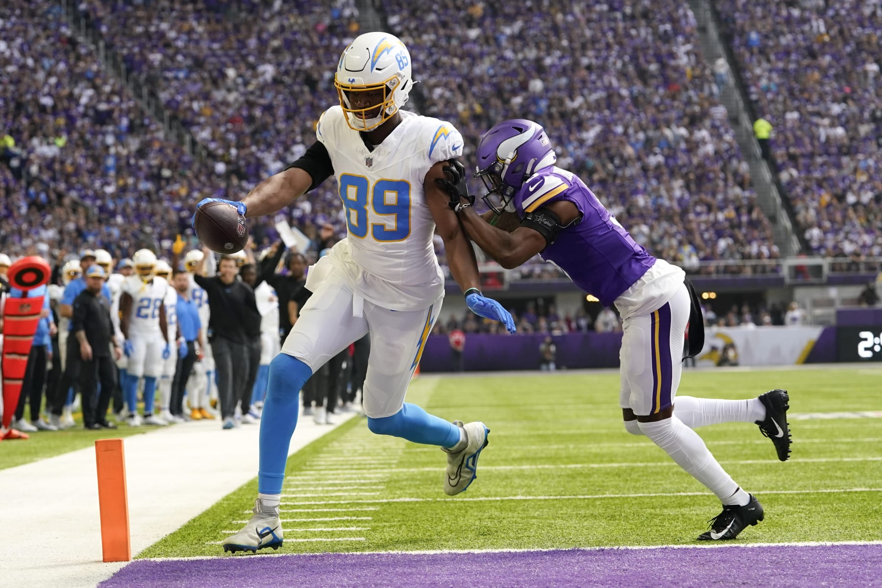 Los Angeles Chargers tight end Donald Parham Jr. (89) catches a 3-yard touchdown pass in front of Minnesota Vikings cornerback Mekhi Blackmon, right, during the first half of an NFL football game, Sunday, Sept. 24, 2023, in Minneapolis. (AP Photo/Abbie Parr)