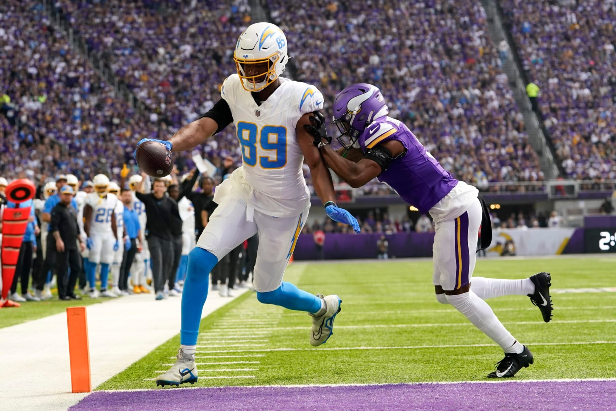 Los Angeles Chargers tight end Donald Parham Jr. (89) catches a 3-yard touchdown pass in front of Minnesota Vikings cornerback Mekhi Blackmon, right, during the first half of an NFL football game, Sunday, Sept. 24, 2023, in Minneapolis. (AP Photo/Abbie Parr)