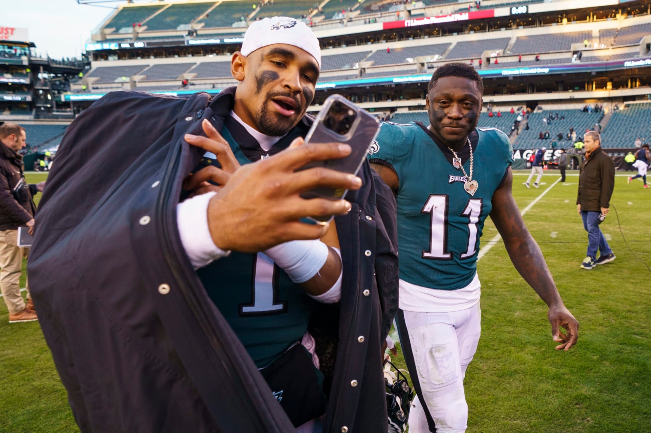 Philadelphia Eagles' Jalen Hurts, left, and Eagles' A.J. Brown pose as they leave the field following the NFL football game, Sunday, Dec. 4, 2022, in Philadelphia. (AP Photo/Chris Szagola)