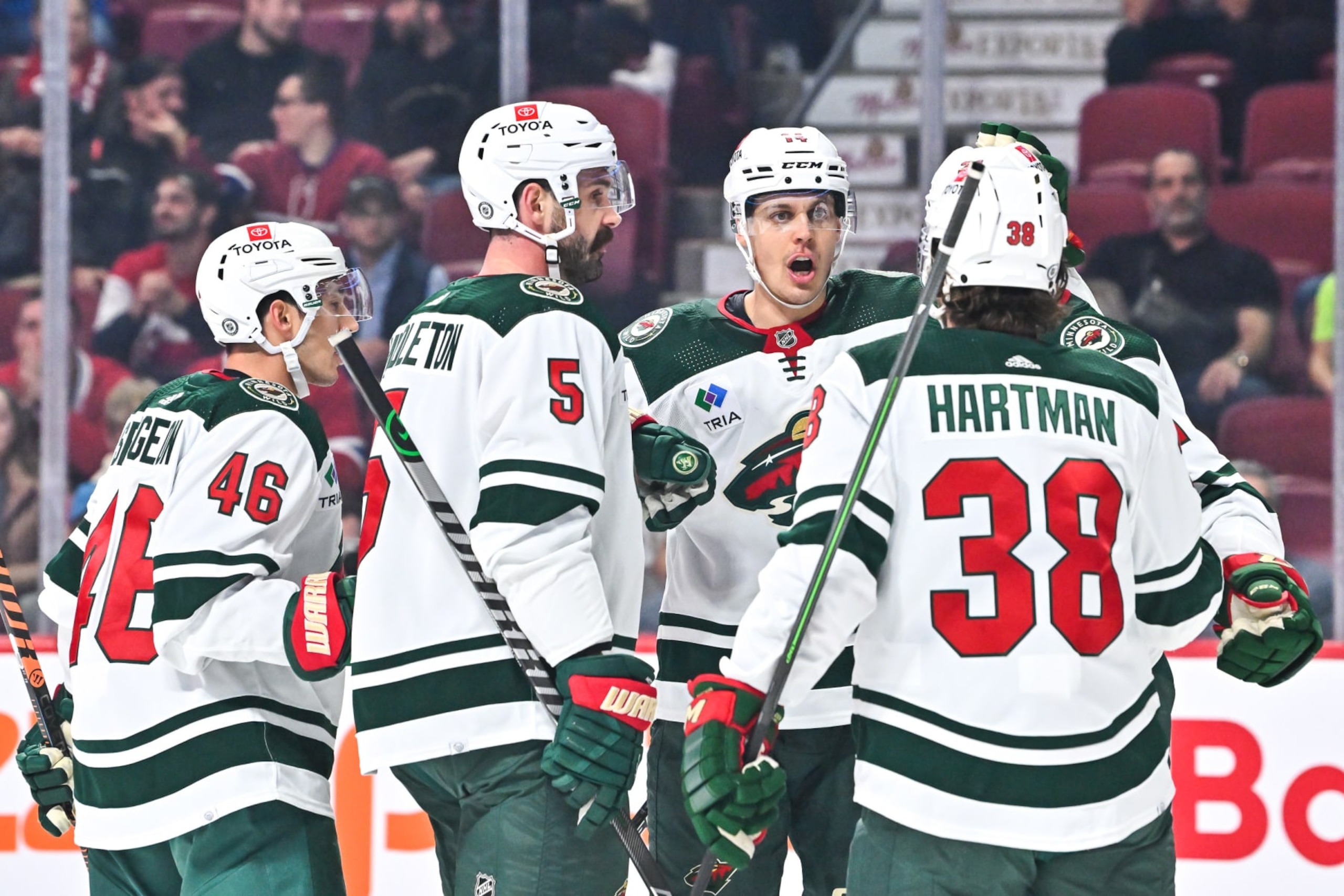 MONTREAL, CANADA - OCTOBER 25:  Joel Eriksson Ek #14 of the Minnesota Wild celebrates his goal with teammates Jared Spurgeon #46, Jacob Middleton #5 and Ryan Hartman #38 during the first period against the Montreal Canadiens at Centre Bell on October 25, 2022 in Montreal, Quebec, Canada.  (Photo by Minas Panagiotakis/Getty Images)