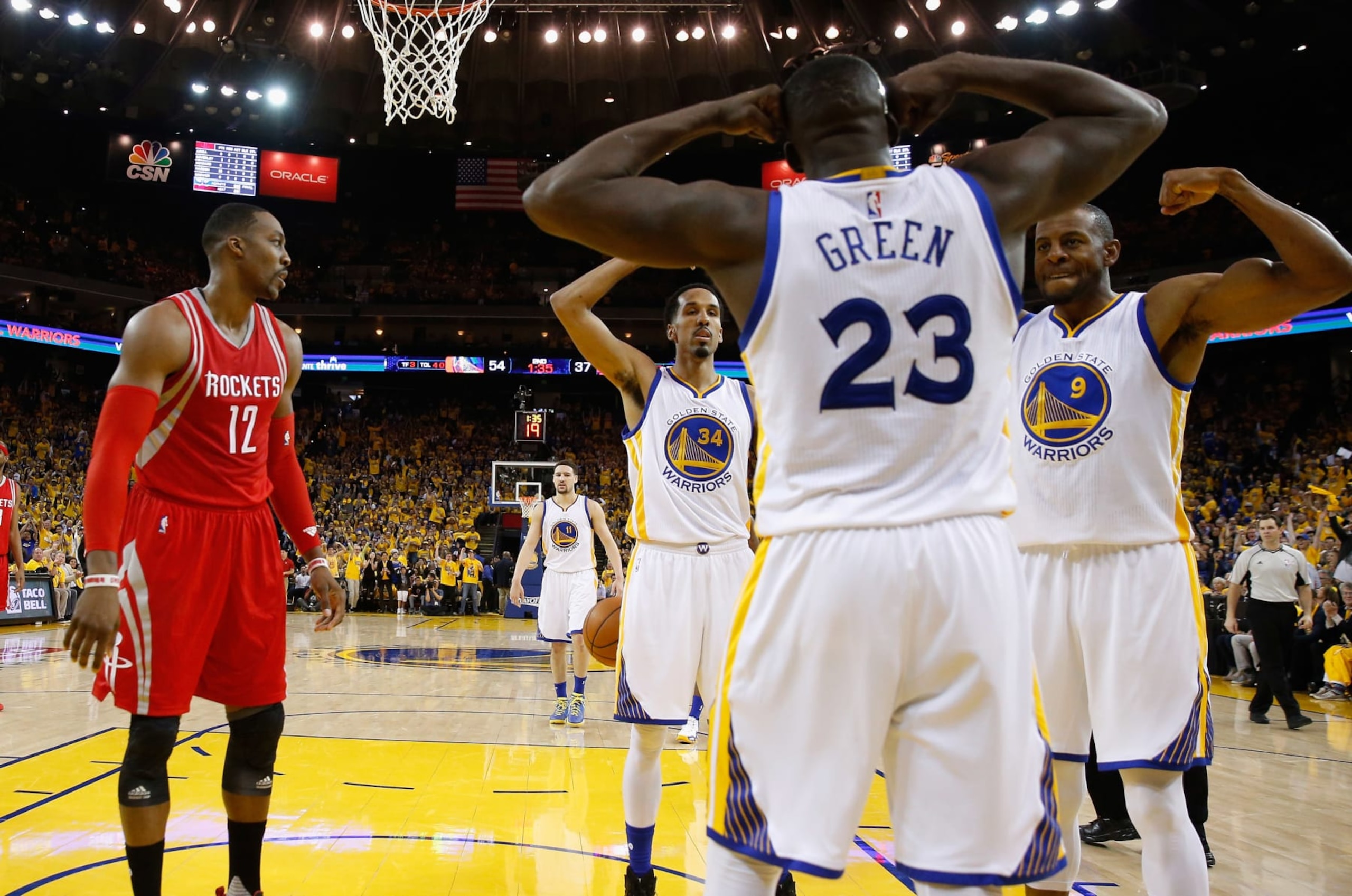 OAKLAND, CA - APRIL 27:  Draymond Green #23 of the Golden State Warriors is congratulated by Shaun Livingston #34 and Andre Iguodala #9 after he made a shot on Dwight Howard #12 of the Houston Rockets in Game Five of the Western Conference Quarterfinals during the 2016 NBA Playoffs at ORACLE Arena on April 27, 2016 in Oakland, California. NOTE TO USER: User expressly acknowledges and agrees that, by downloading and or using this photograph, user is consenting to the terms and conditions of Getty Images License Agreement.  (Photo by Ezra Shaw/Getty Images)