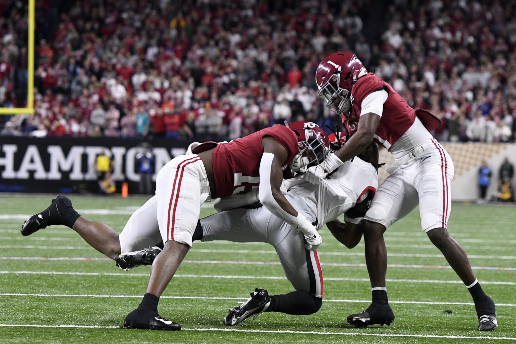 INDIANAPOLIS, IN - JANUARY 10: Alabama Crimson Tide LB Dallas Turner (15) and Alabama Crimson Tide DB Kool-Aid McKinstry (1) tackle Georgia Bulldogs RB James Cook (4) during the Alabama Crimson Tide versus the Georgia Bulldogs in the College Football Playoff National Championship, on January 10, 2022, at Lucas Oil Stadium in Indianapolis, IN. (Photo by Michael Allio/Icon Sportswire via Getty Images)