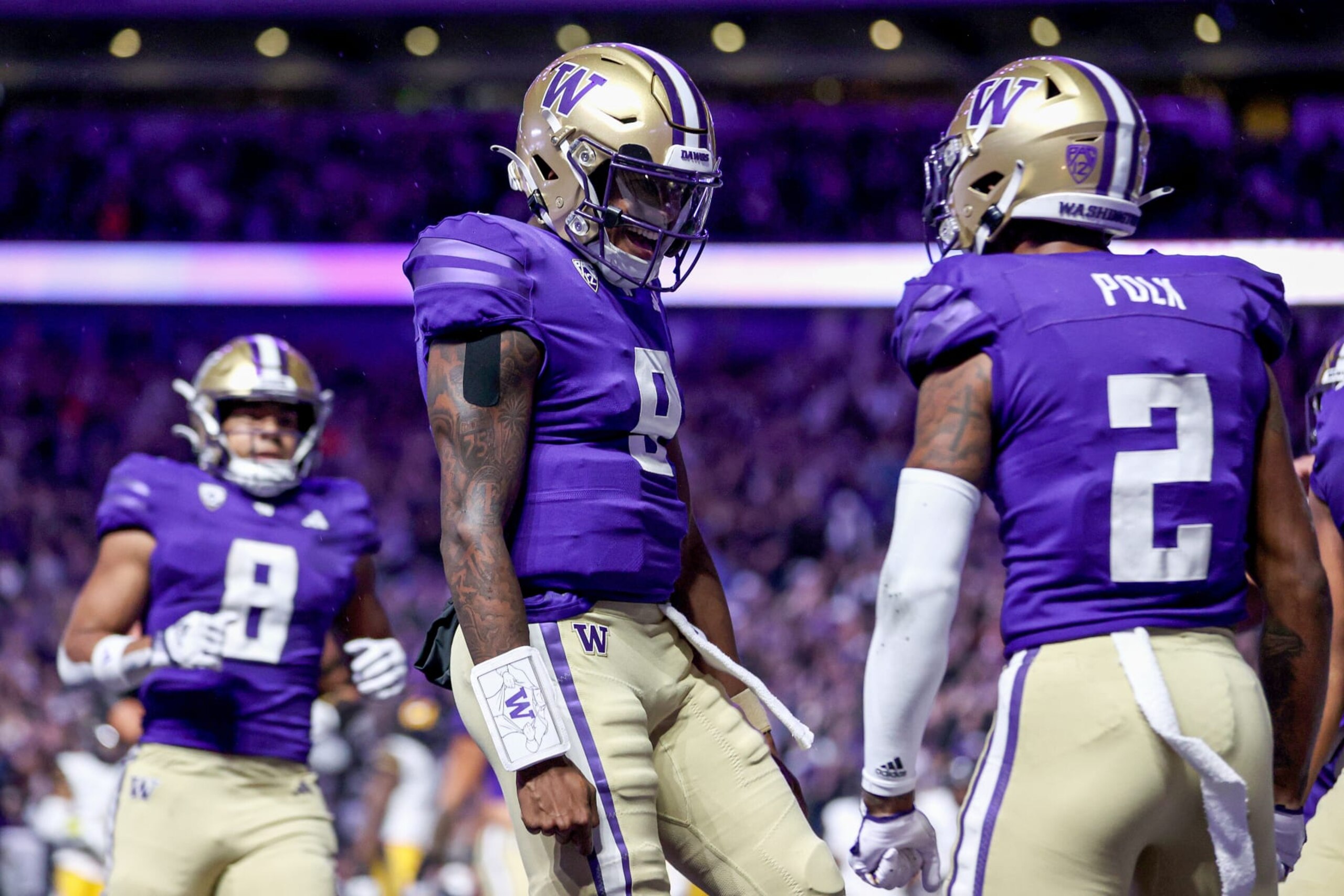SEATTLE, WASHINGTON - SEPTEMBER 23: Michael Penix Jr. #9 and Ja'Lynn Polk #2 of the Washington Huskies celebrate their touchdown during the first quarter against the California Golden Bears at Husky Stadium on September 23, 2023 in Seattle, Washington. (Photo by Steph Chambers/Getty Images)