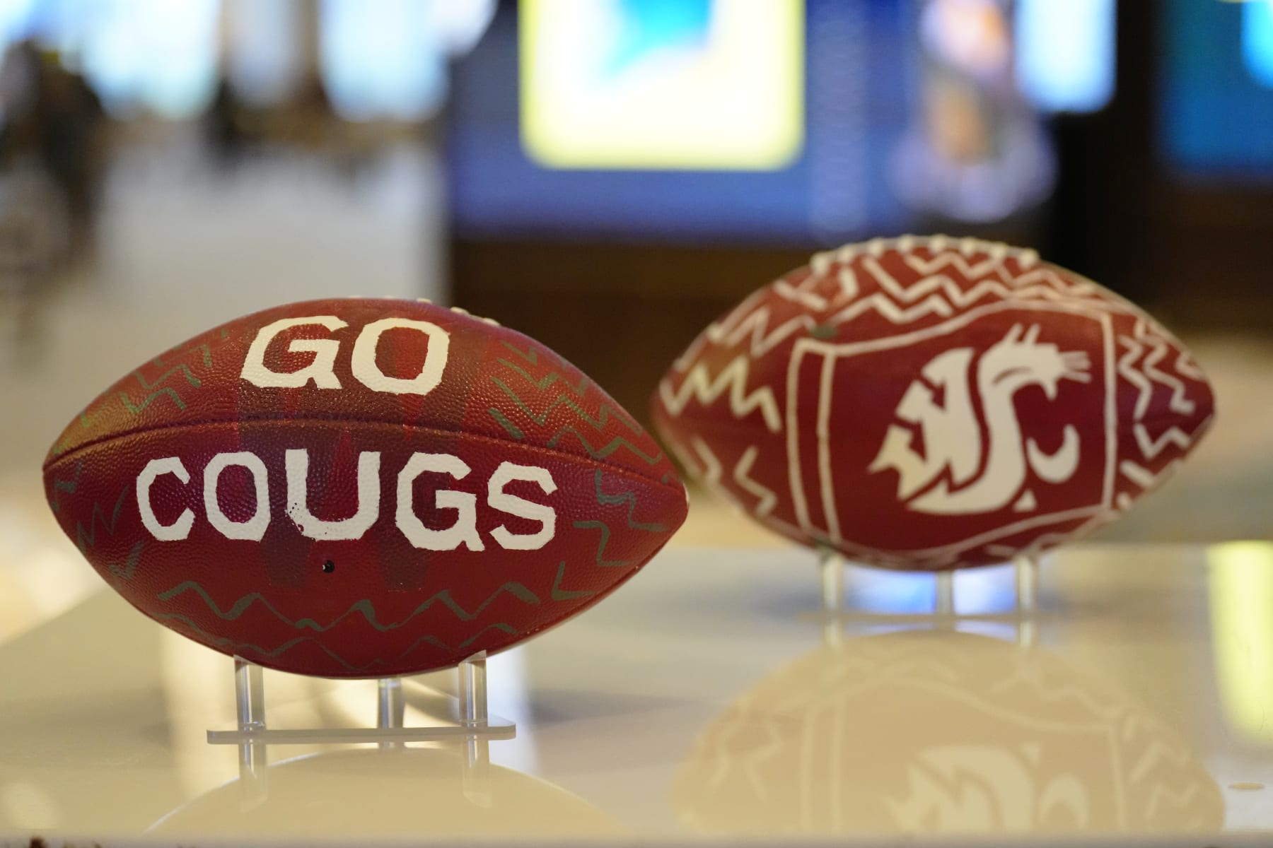 LAS VEGAS, NEVADA - JULY 21: Custom painted Pac-12 Washington State Cougars football on display at Zouk Nightclub at Resorts World Las Vegas on July 21, 2023 in Las Vegas, Nevada. (Photo by Louis Grasse/Getty Images)
