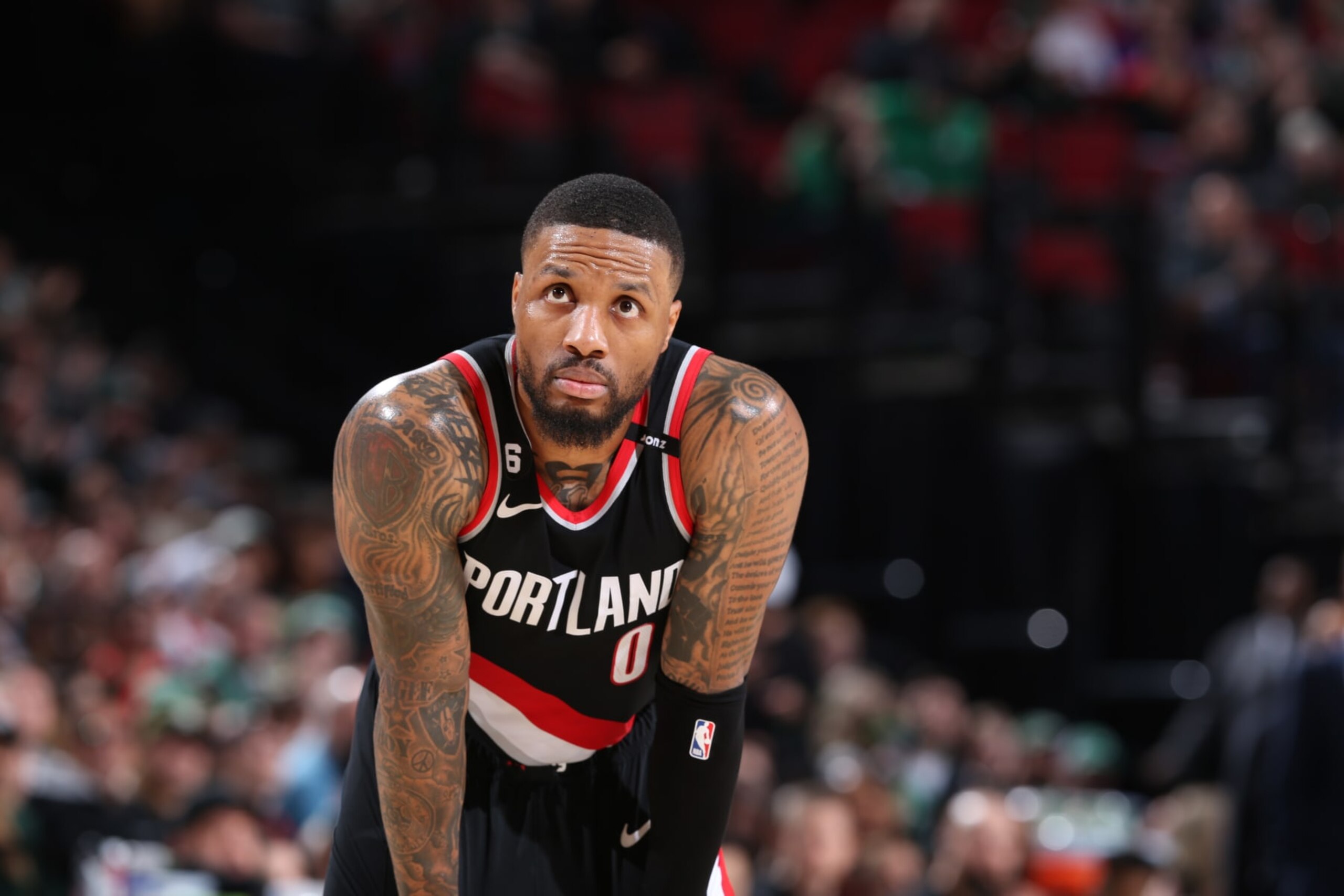 PORTLAND, OR - MARCH 17: Damian Lillard #0 of the Portland Trail Blazers looks on during the game against the Boston Celtics  on March 17, 2023 at the Moda Center Arena in Portland, Oregon. NOTE TO USER: User expressly acknowledges and agrees that, by downloading and or using this photograph, user is consenting to the terms and conditions of the Getty Images License Agreement. Mandatory Copyright Notice: Copyright 2023 NBAE (Photo by Sam Forencich/NBAE via Getty Images)