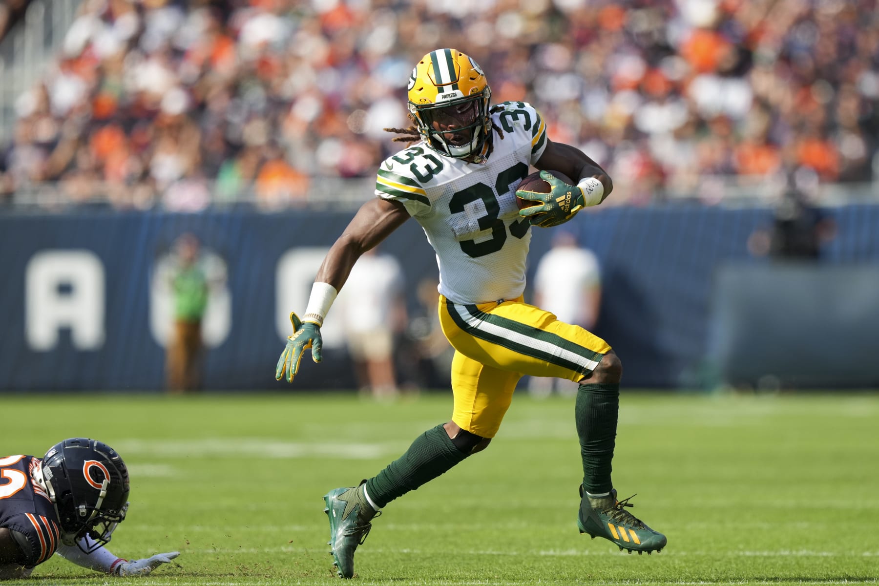 CHICAGO, IL - SEPTEMBER 10:  Running Back Aaron Jones #33 of the Green Bay Packers runs the ball during an NFL football game against the Chicago Bears at Soldier Field on September 10, 2023 in Chicago, Illinois. (Photo by Todd Rosenberg/Getty Images)