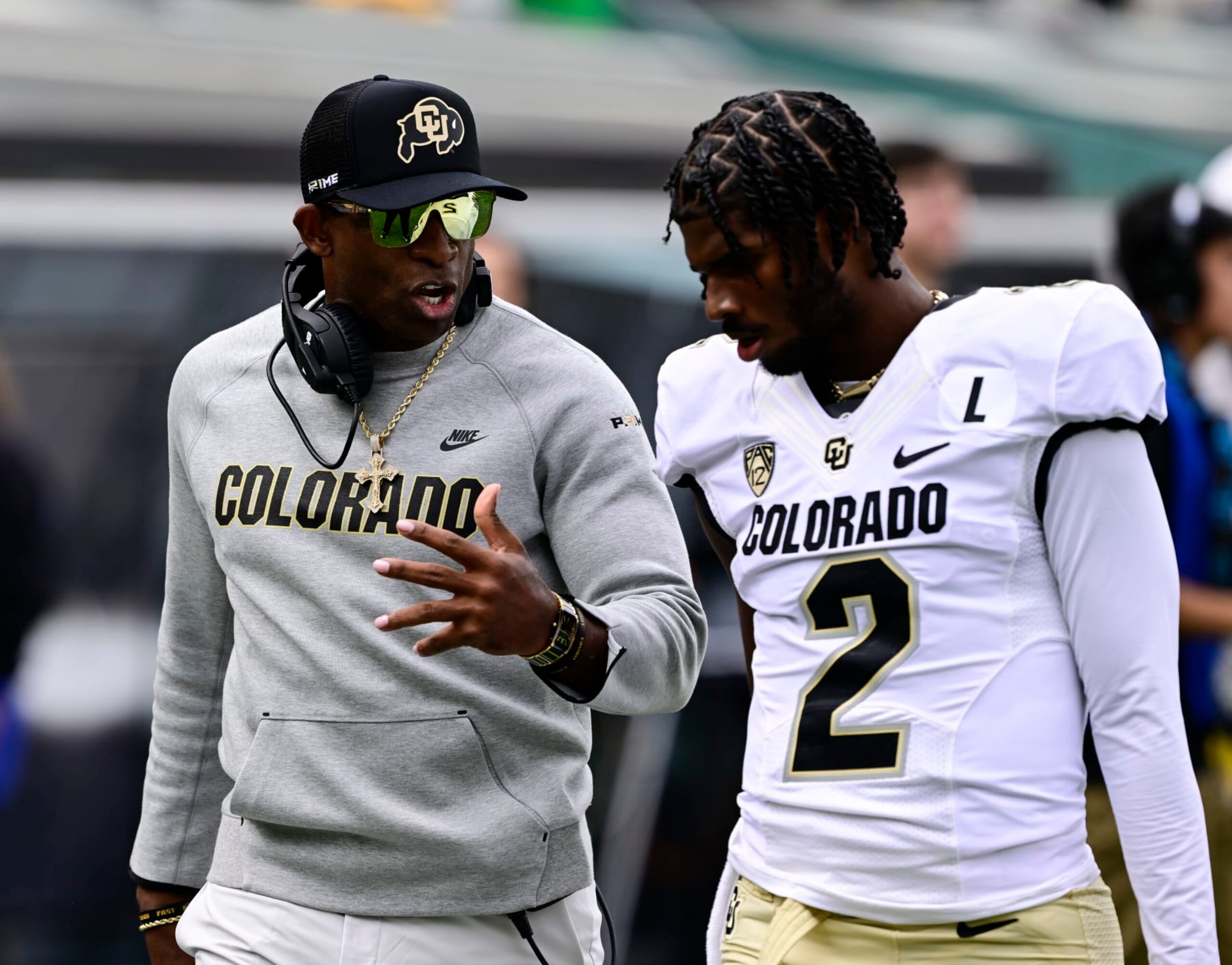 EUGENE, OR - SEPTEMBER 23: Colorado Buffaloes head coach Deion Sanders talks with his son Colorado Buffaloes quarterback Shedeur Sanders (2) before the game against the Oregon Ducks at Autzen Stadium September 23, 2023. (Photo by Andy Cross/MediaNews Group/The Denver Post via Getty Images)
