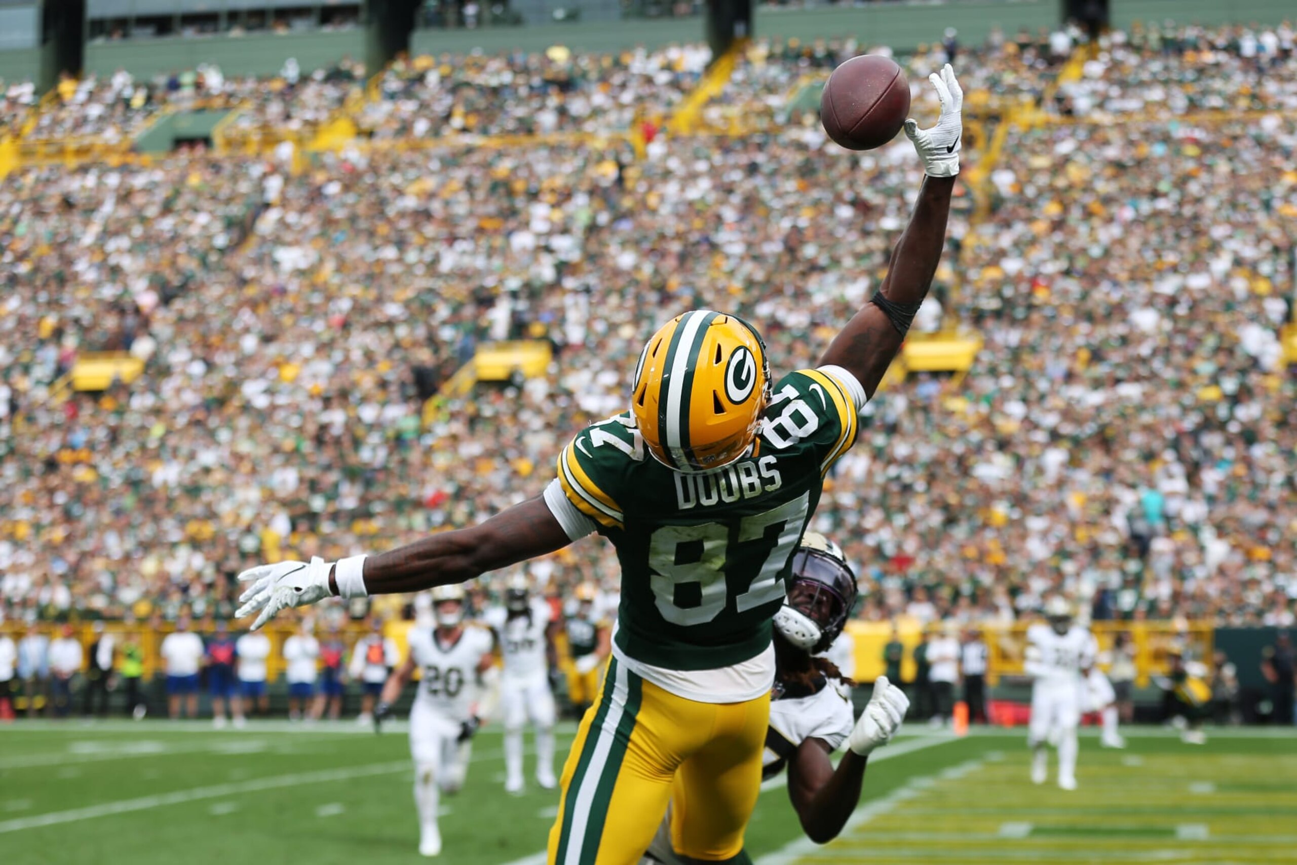 GREEN BAY, WI - SEPTEMBER 24: Green Bay Packers wide receiver Romeo Doubs (87) reaches back for a ball during a game between the Green Bay Packers and the New Orleans Saints on September 24, 2023 at Lambeau Field in Green Bay, WI. (Photo by Larry Radloff/Icon Sportswire via Getty Images)