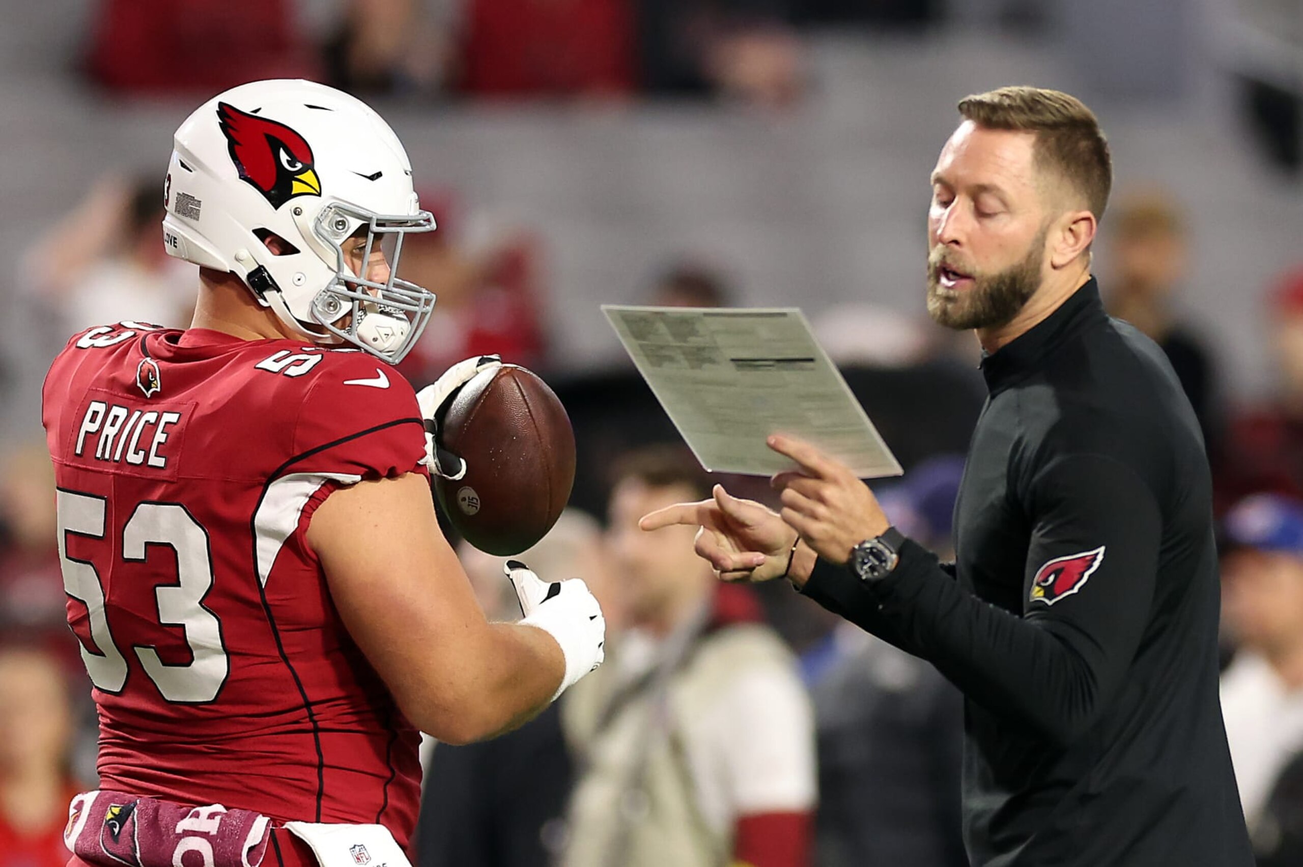 GLENDALE, ARIZONA - DECEMBER 25:  Head coach Kliff Kingsbury of the Arizona Cardinals talks with Billy Price #53 prior tot he game against the Tampa Bay Buccaneers at State Farm Stadium on December 25, 2022 in Glendale, Arizona. (Photo by Christian Petersen/Getty Images)