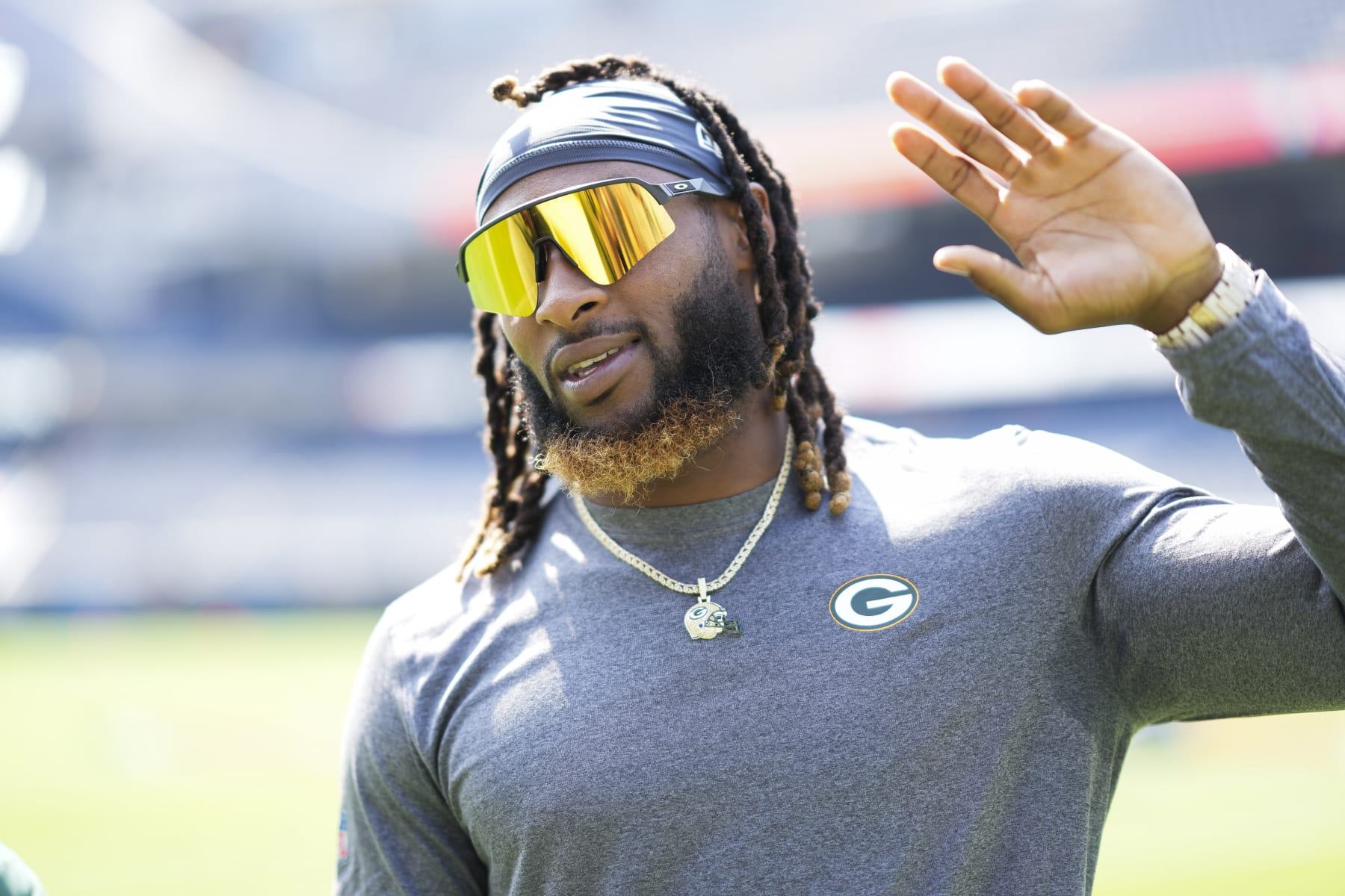 CHICAGO, IL - SEPTEMBER 10:  Running back Aaron Jones #33 of the Green Bay Packers waves prior to an NFL football game against the Chicago Bears at Soldier Field on September 10, 2023 in Chicago, Illinois. (Photo by Todd Rosenberg/Getty Images)