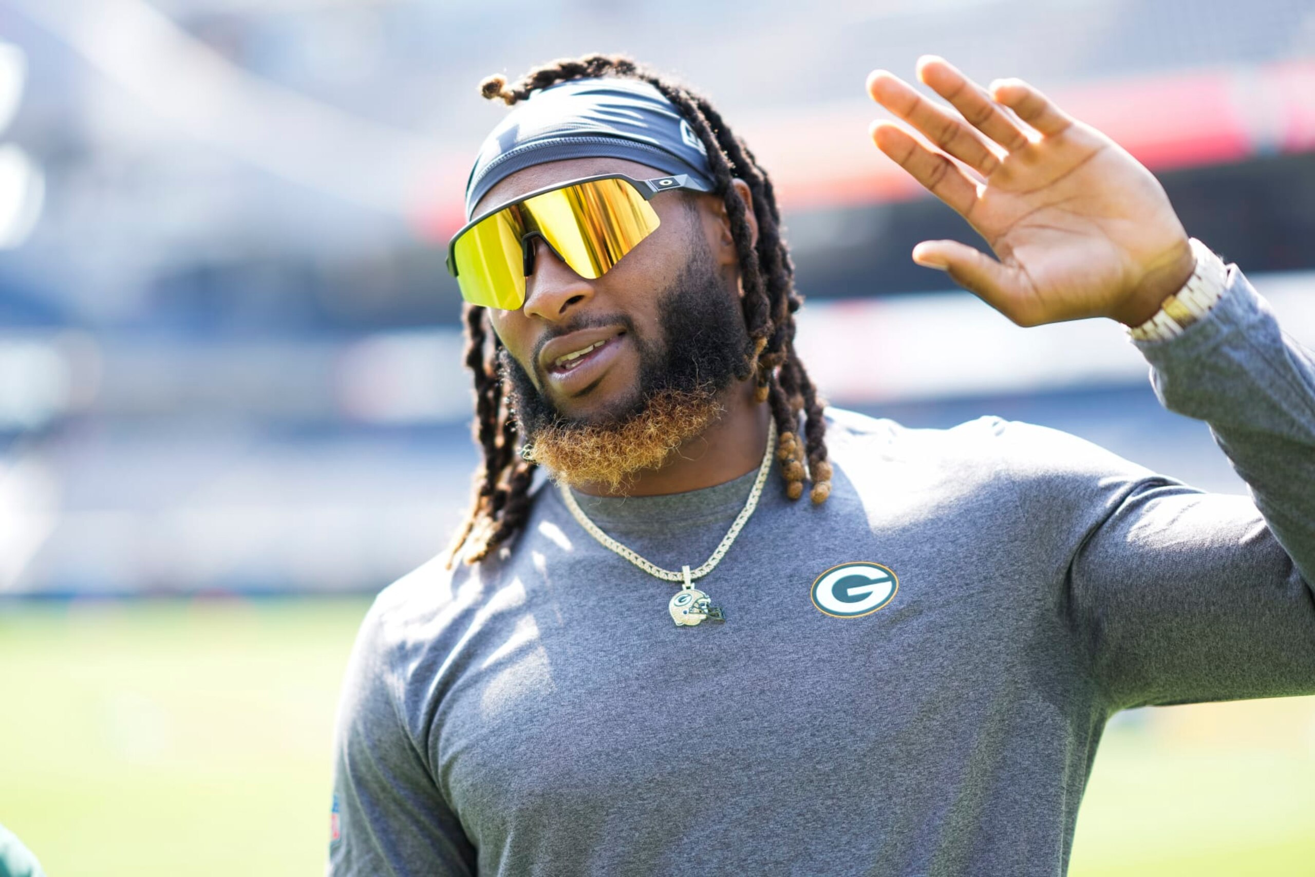 CHICAGO, IL - SEPTEMBER 10:  Running back Aaron Jones #33 of the Green Bay Packers waves prior to an NFL football game against the Chicago Bears at Soldier Field on September 10, 2023 in Chicago, Illinois. (Photo by Todd Rosenberg/Getty Images)