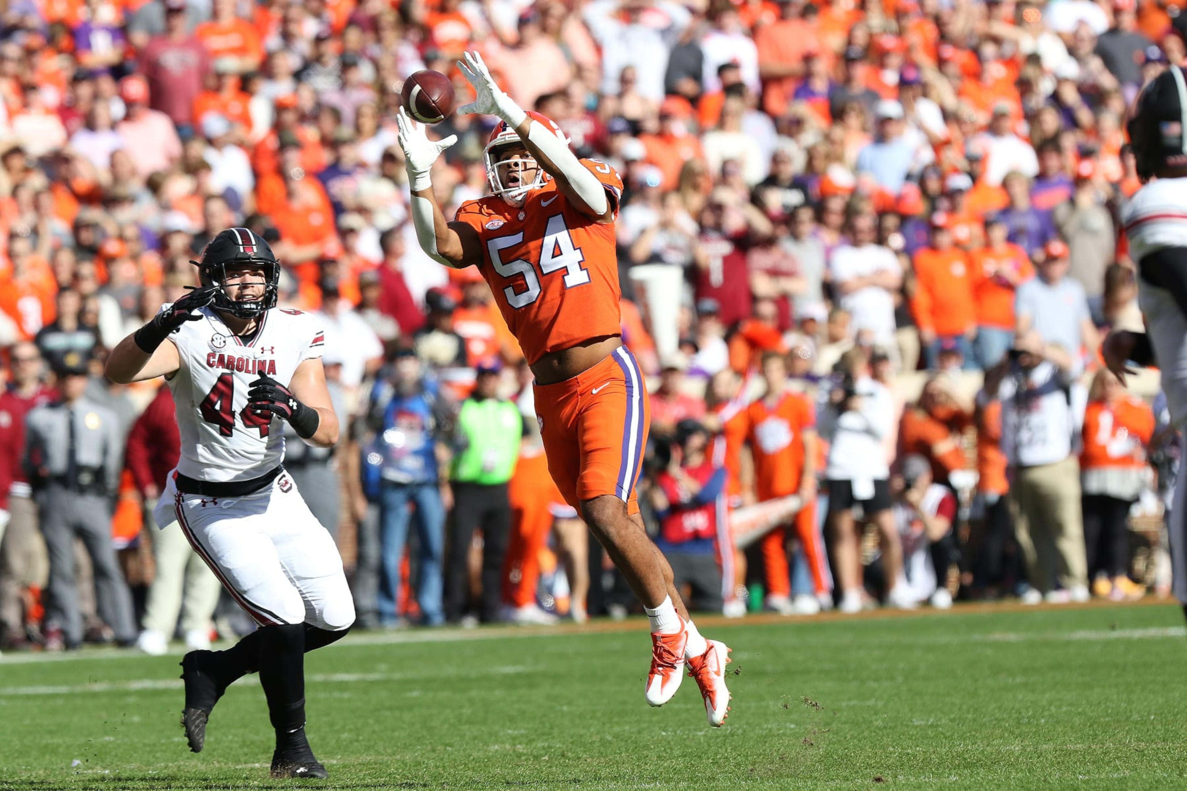 CLEMSON, SC - NOVEMBER 26: Clemson Tigers linebacker Jeremiah Trotter Jr. (54) catches an interception that he would run back for a touch down during a college football game between the South Carolina Gamecocks and the Clemson Tigers on November 26, 2022, at Clemson Memorial Stadium in Clemson, S.C. (Photo by John Byrum/Icon Sportswire via Getty Images) CLEMSON, SC - NOVEMBER 26: Clemson Tigers linebacker Jeremiah Trotter Jr. (54) catches an interception that he would run back for a touch down during a college football game between the South Carolina Gamecocks and the Clemson Tigers on November 26, 2022, at Clemson Memorial Stadium in Clemson, S.C. (Photo by John Byrum/Icon Sportswire via Getty Images)
