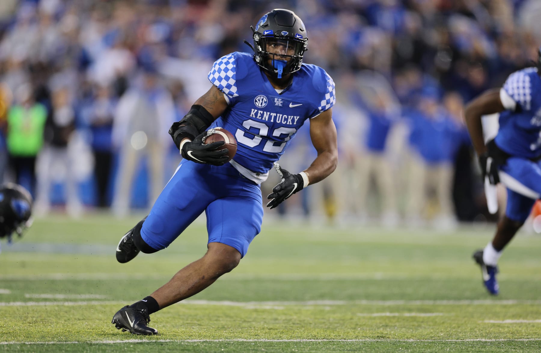 LEXINGTON, KENTUCKY - NOVEMBER 26:  	Trevin Wallace #32 of the Kentucky Wildcats runs with the ball after intercepting a pass against the Louisville Cardinals at Kroger Field on November 26, 2022 in Lexington, Kentucky. (Photo by Andy Lyons/Getty Images)