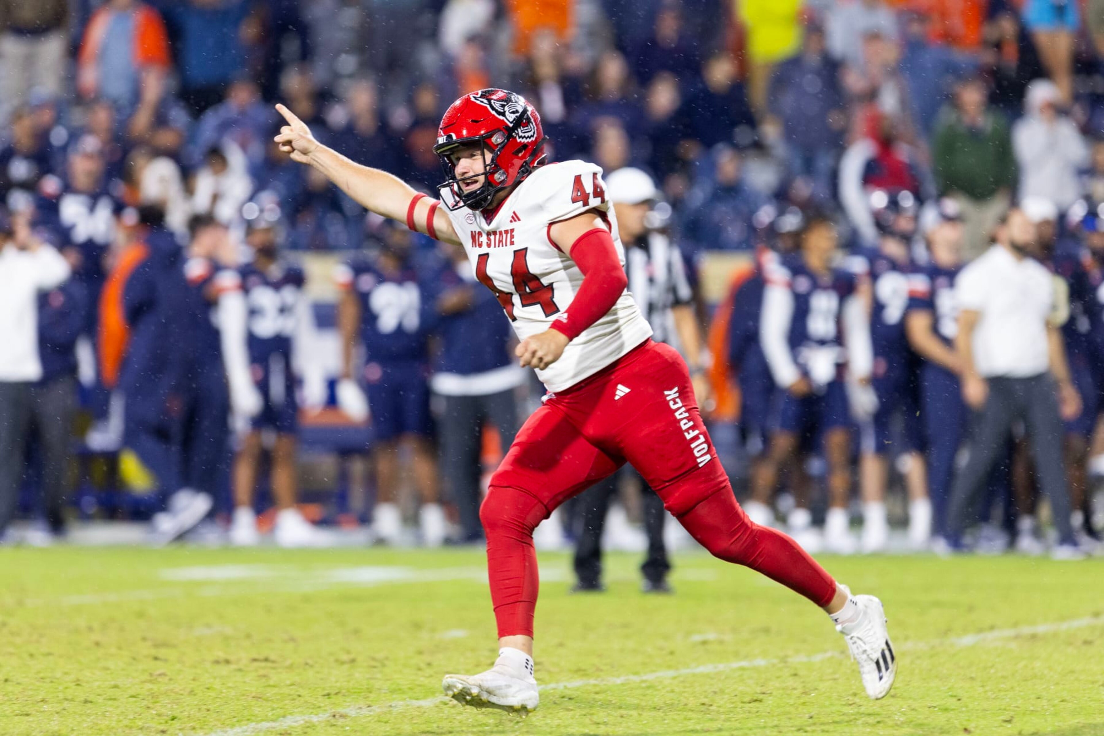 CHARLOTTESVILLE, VIRGINIA - SEPTEMBER 22: Brayden Narveson #44 of the NC State Wolfpack celebrates after kicking the game-winning field goal in the second half during a game against the Virginia Cavaliers at Scott Stadium on September 22, 2023 in Charlottesville, Virginia. (Photo by Ryan M. Kelly/Getty Images)