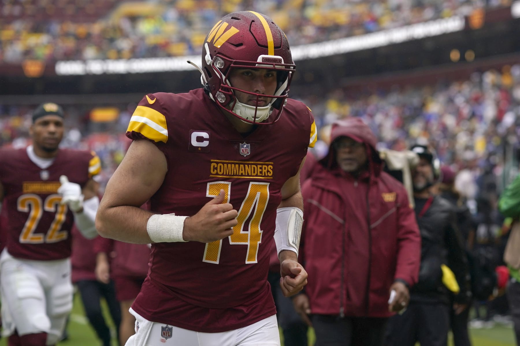 LANDOVER, MARYLAND - SEPTEMBER 24: Sam Howell #14 of the Washington Commanders jogs to the locker room for halftime against the Buffalo Bills at FedExField on September 24, 2023 in Landover, Maryland. (Photo by Jess Rapfogel/Getty Images)