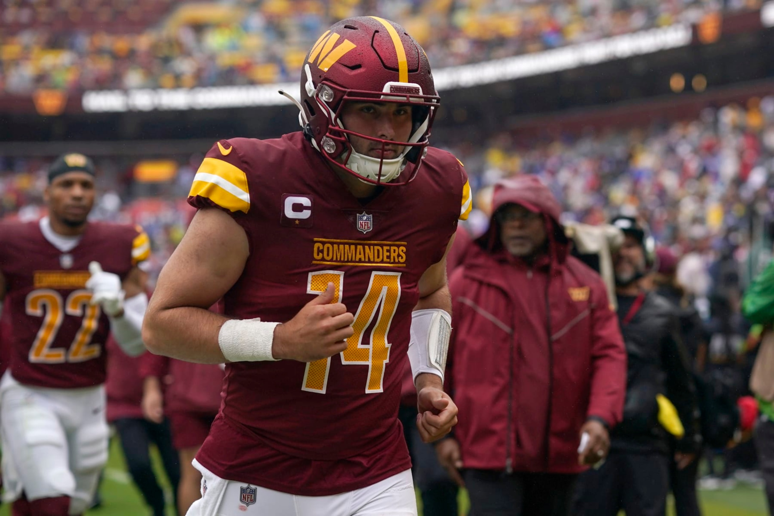 LANDOVER, MARYLAND - SEPTEMBER 24: Sam Howell #14 of the Washington Commanders jogs to the locker room for halftime against the Buffalo Bills at FedExField on September 24, 2023 in Landover, Maryland. (Photo by Jess Rapfogel/Getty Images)