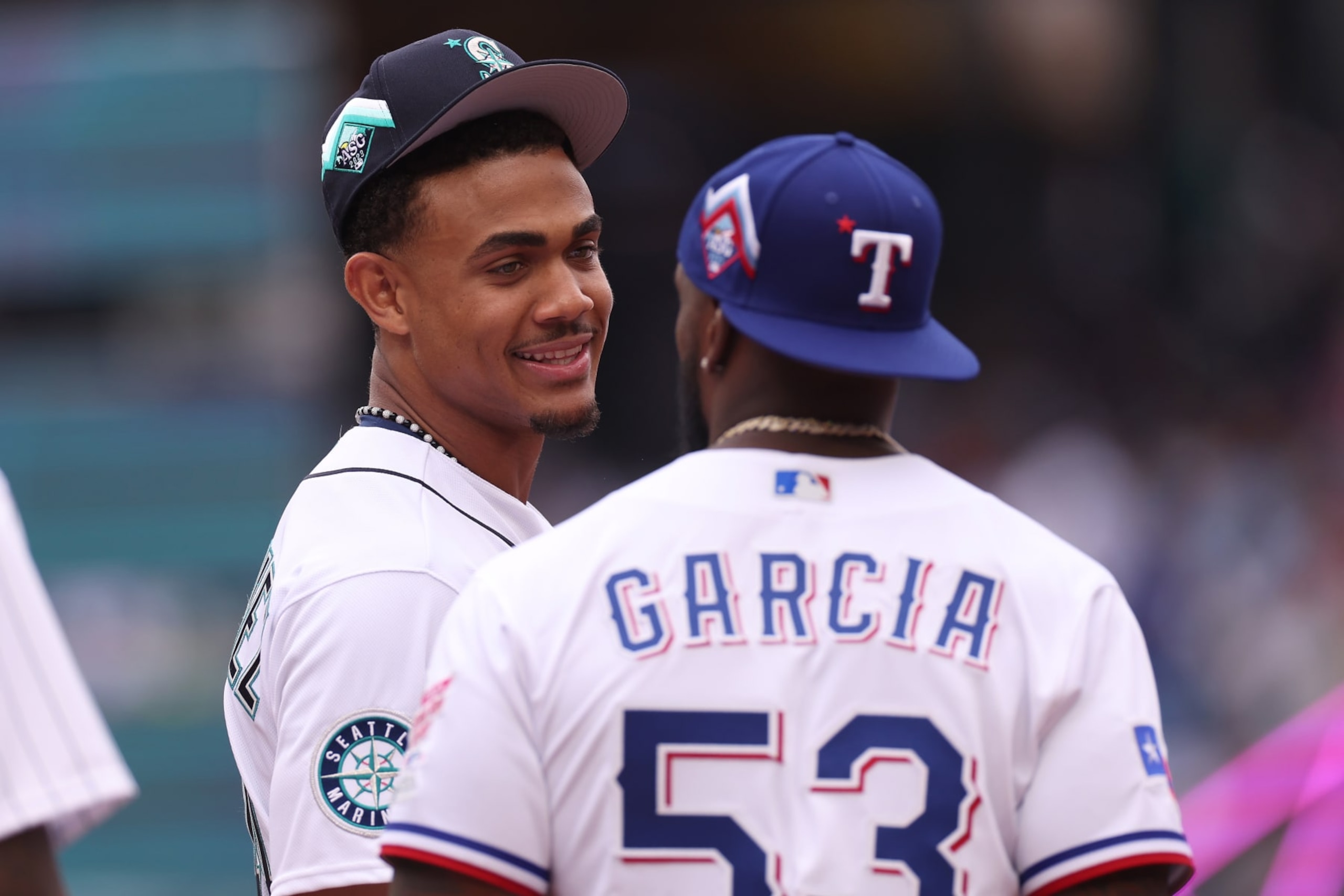 SEATTLE, WASHINGTON - JULY 10: Julio Rodríguez #44 of the Seattle Mariners speaks with Adolis García #53 of the Texas Rangers prior to the start of the T-Mobile Home Run Derby at T-Mobile Park on July 10, 2023 in Seattle, Washington. (Photo by Steph Chambers/Getty Images)