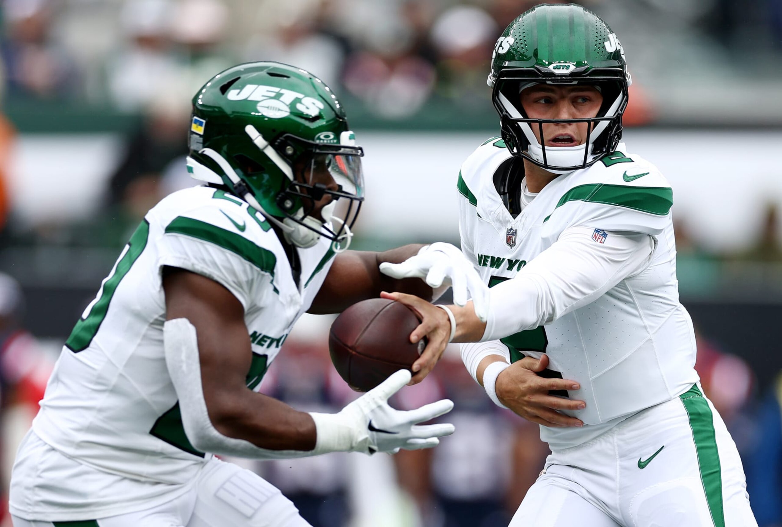 EAST RUTHERFORD, NEW JERSEY - SEPTEMBER 24: Zach Wilson #2 of the New York Jets hands the ball off to Breece Hall #20 in the first half against the New England Patriots at MetLife Stadium on September 24, 2023 in East Rutherford, New Jersey. (Photo by Elsa/Getty Images)