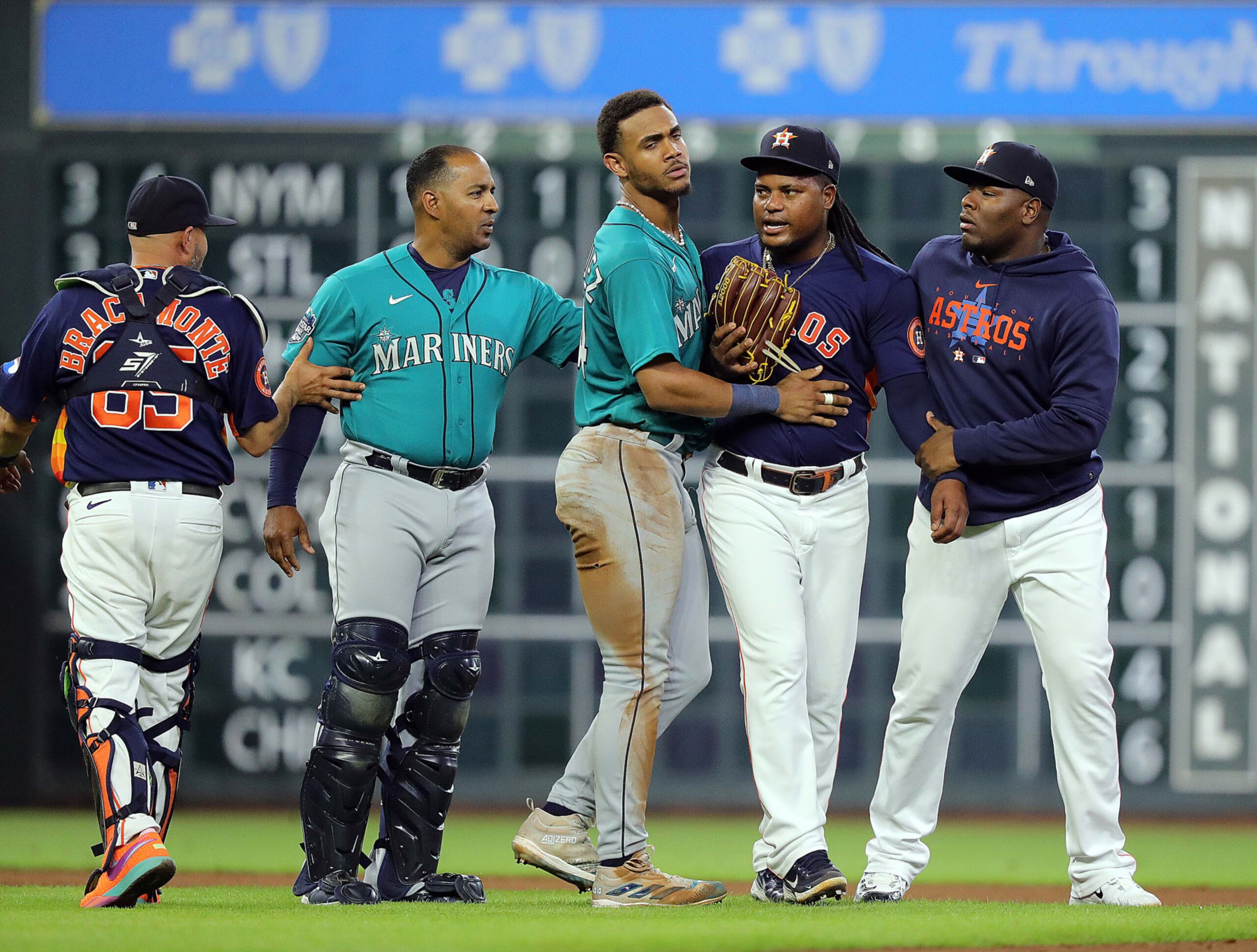 HOUSTON, TEXAS - AUGUST 19: Framber Valdez #59 of the Houston Astros is restrained by Julio Rodriguez #44 of the Seattle Mariners and Hector Neris after both benches cleared when Jose Caballero #76 was hit by a pitch in the fifth inning at Minute Maid Park on August 19, 2023 in Houston, Texas. (Photo by Bob Levey/Getty Images)