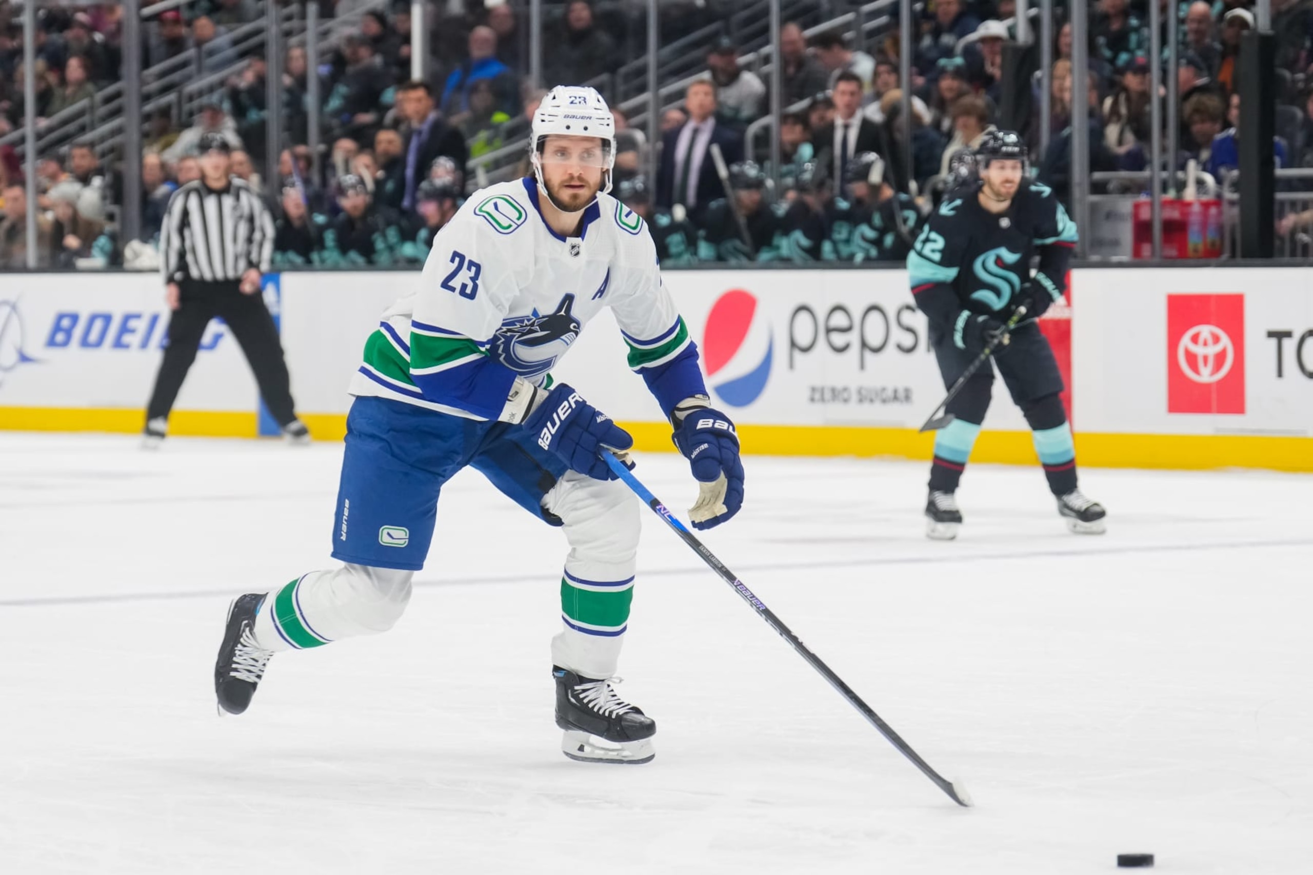 SEATTLE, WASHINGTON - JANUARY 25: Oliver Ekman-Larsson #23 of the Vancouver Canucks skates back for the puck during the first period of a game against the Seattle Kraken at Climate Pledge Arena on January 25, 2023 in Seattle, Washington. (Photo by Christopher Mast/NHLI via Getty Images)