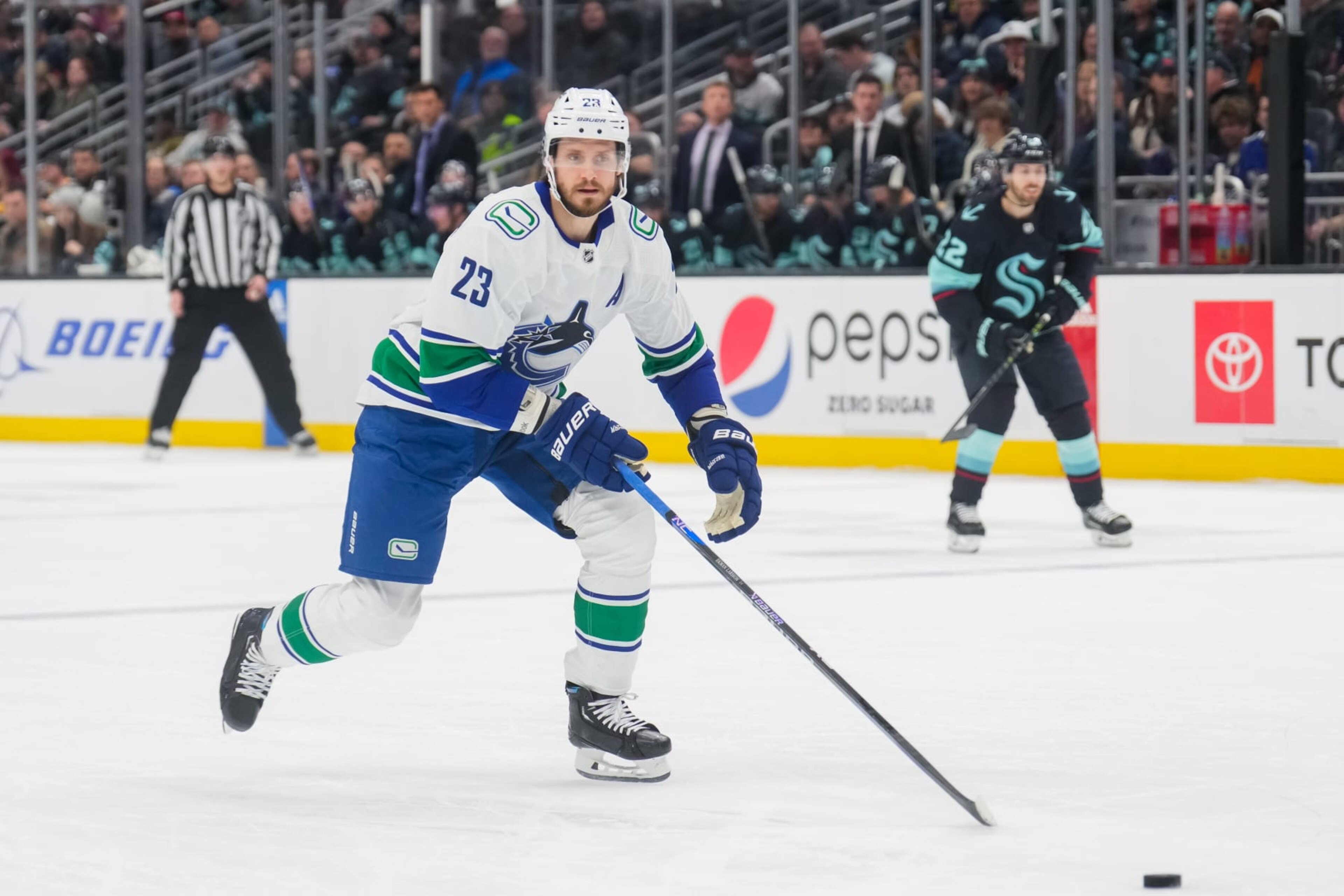 SEATTLE, WASHINGTON - JANUARY 25: Oliver Ekman-Larsson #23 of the Vancouver Canucks skates back for the puck during the first period of a game against the Seattle Kraken at Climate Pledge Arena on January 25, 2023 in Seattle, Washington. (Photo by Christopher Mast/NHLI via Getty Images)