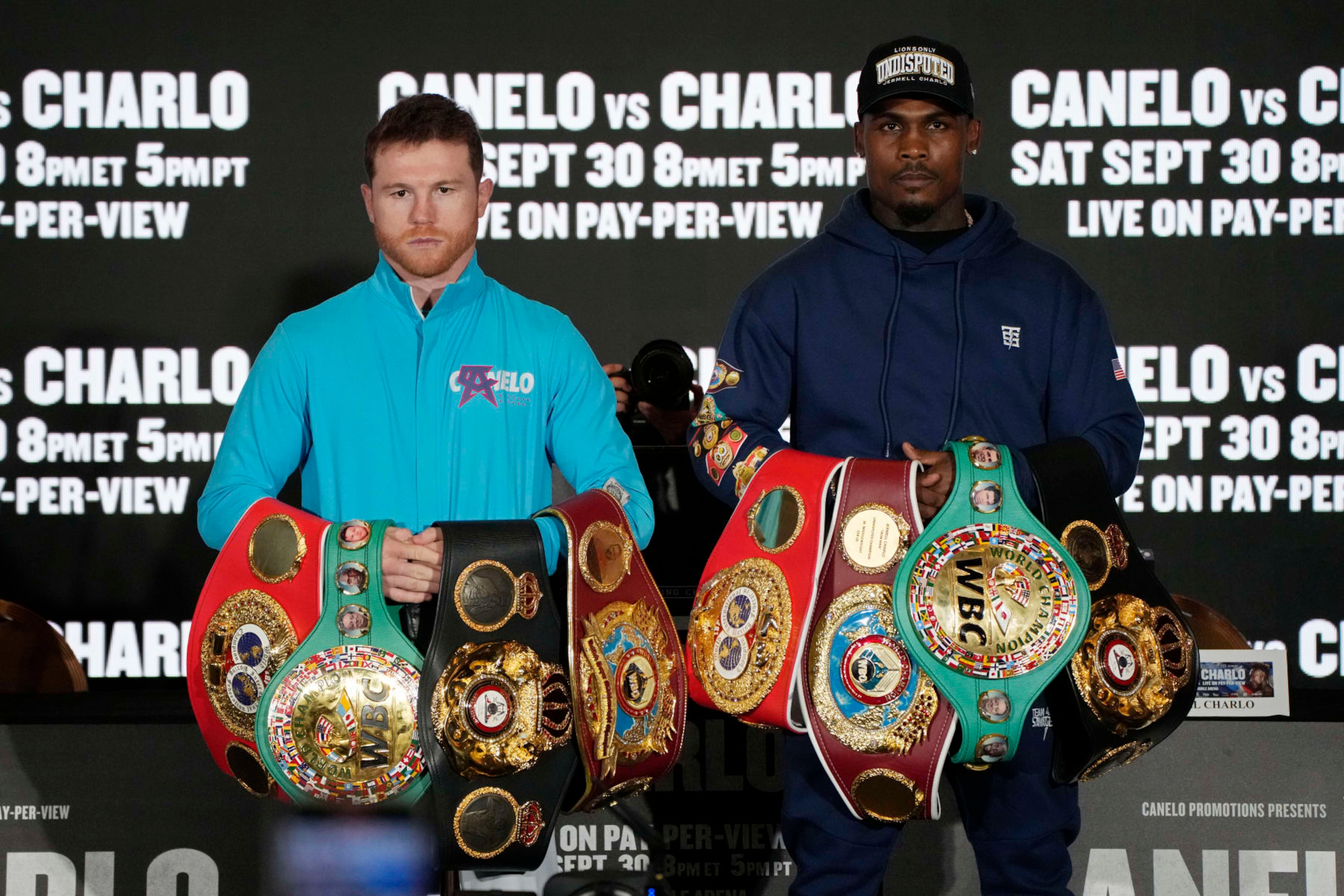 Canelo Alvarez, left, of Mexico, and Jermell Charlo pose during a news conference Wednesday, Sept. 27, 2023, in Las Vegas. The two are scheduled to fight in a super middleweight title boxing match Saturday in Las Vegas. (AP Photo/John Locher)