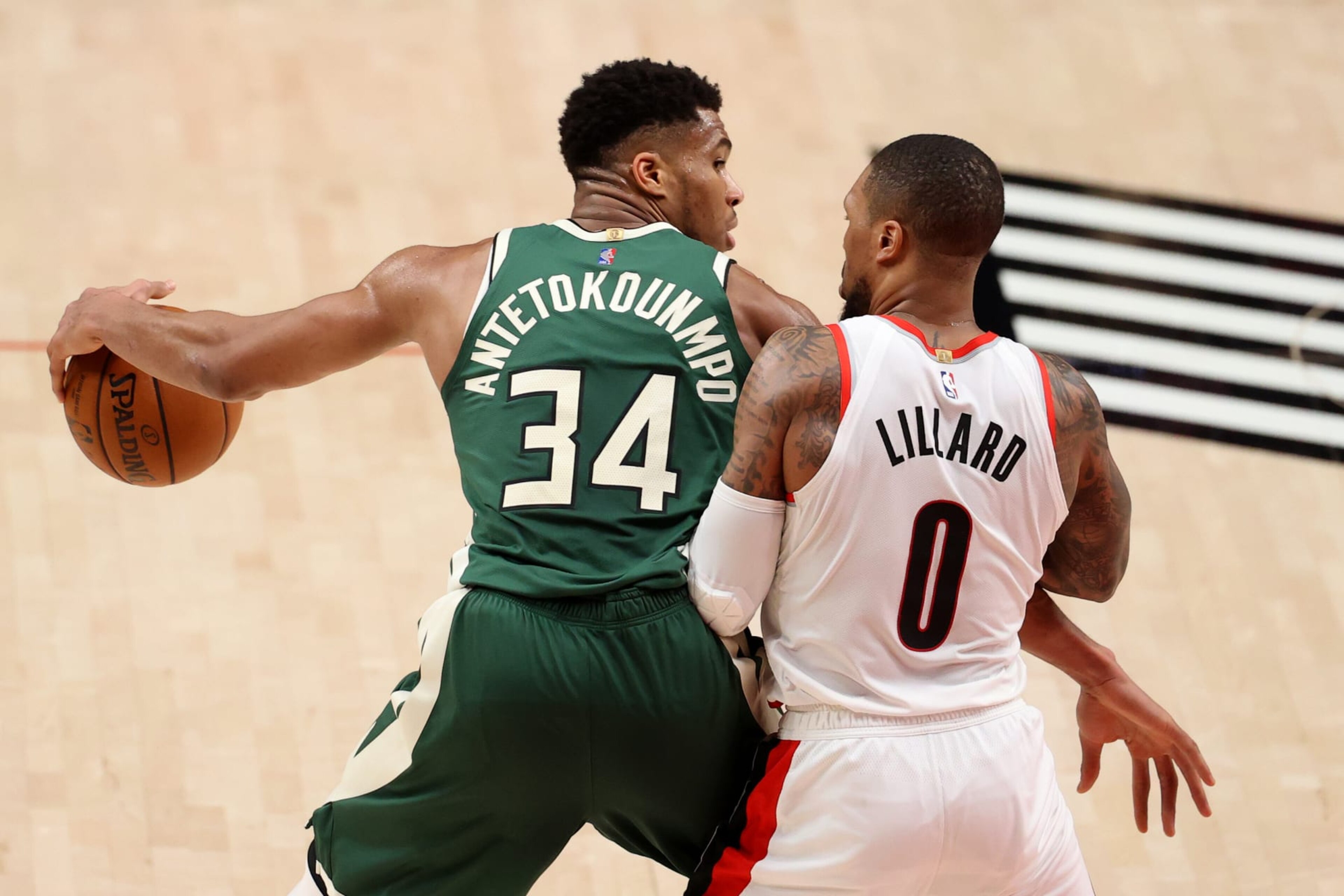 PORTLAND, OREGON - APRIL 02: Giannis Antetokounmpo #34 of the Milwaukee Bucks dribbles against Damian Lillard #0 of the Portland Trail Blazers in the third quarter at Moda Center on April 02, 2021 in Portland, Oregon. NOTE TO USER: User expressly acknowledges and agrees that, by downloading and or using this photograph, User is consenting to the terms and conditions of the Getty Images License Agreement. (Photo by Abbie Parr/Getty Images) PORTLAND, OREGON - APRIL 02: Giannis Antetokounmpo #34 of the Milwaukee Bucks dribbles against Damian Lillard #0 of the Portland Trail Blazers in the third quarter at Moda Center on April 02, 2021 in Portland, Oregon. NOTE TO USER: User expressly acknowledges and agrees that, by downloading and or using this photograph, User is consenting to the terms and conditions of the Getty Images License Agreement. (Photo by Abbie Parr/Getty Images)