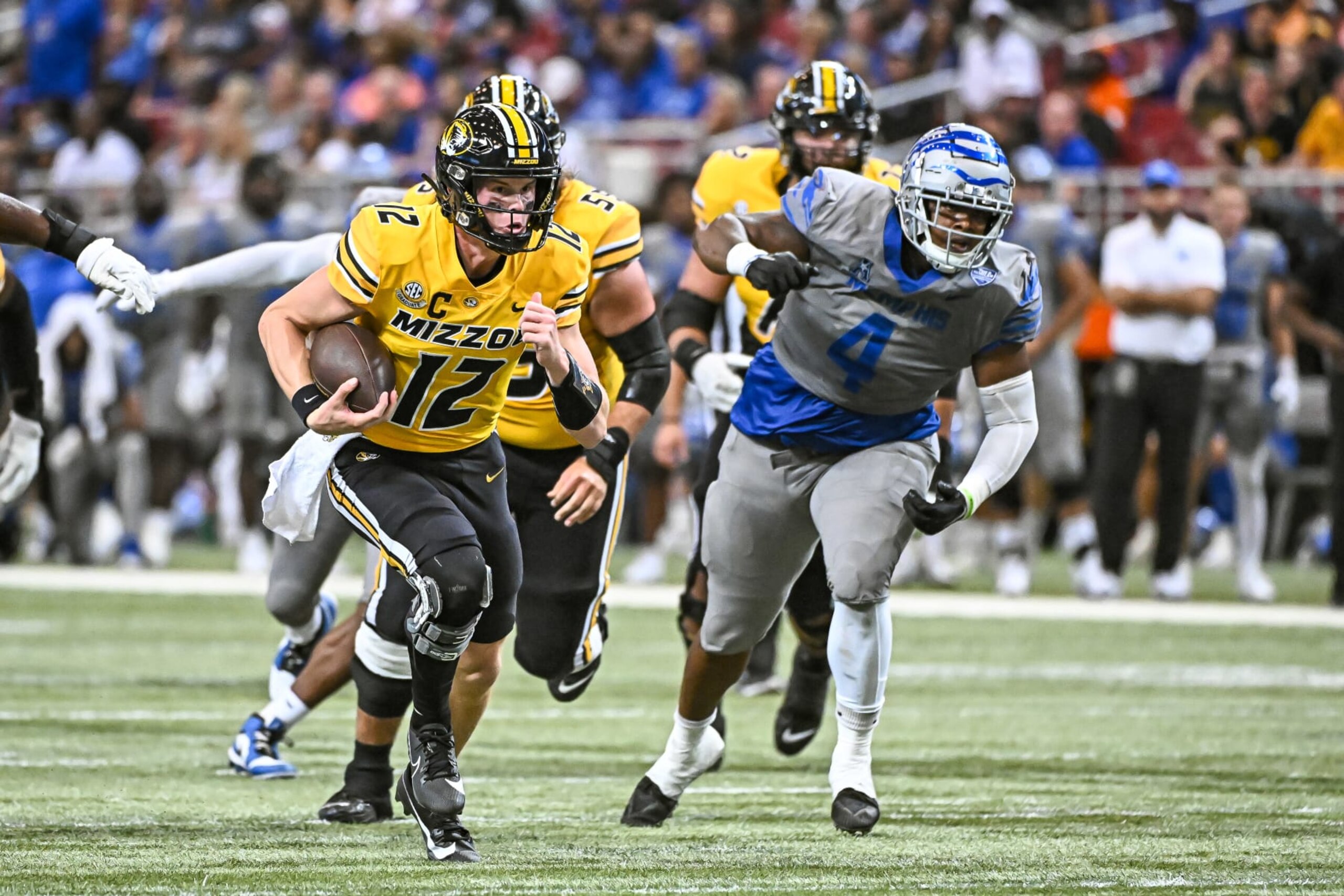 ST. LOUIS, MO - SEPTEMBER 23: Missouri Tigers defensive back Dreyden Norwood (12) finds some open space to run for a first down after getting past Memphis Tigers defensive lineman Josh Ellison (4) during a non conference game between the Memphis Tigers and the Missouri Tigers held on Saturday Sep 23, 2023 at The Dome in St. Louis, MO. (Photo by Rick Ulreich/Icon Sportswire via Getty Images