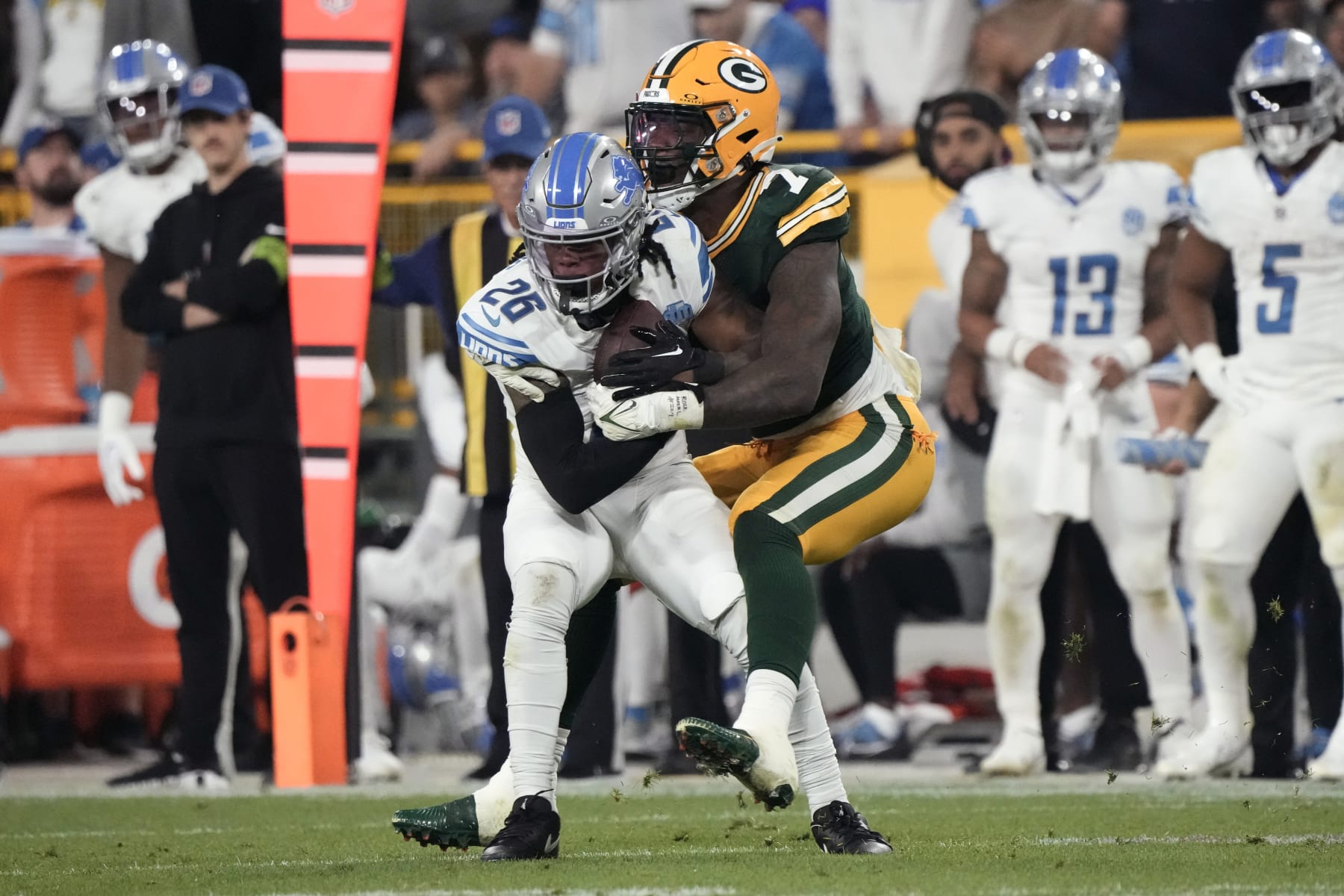 Detroit Lions running back Jahmyr Gibbs (26) is tackled by Green Bay Packers linebacker Quay Walker (7) after catching a pass during the second half of an NFL football game, Thursday, Sept. 28, 2023, in Green Bay, Wis. (AP Photo/Morry Gash)