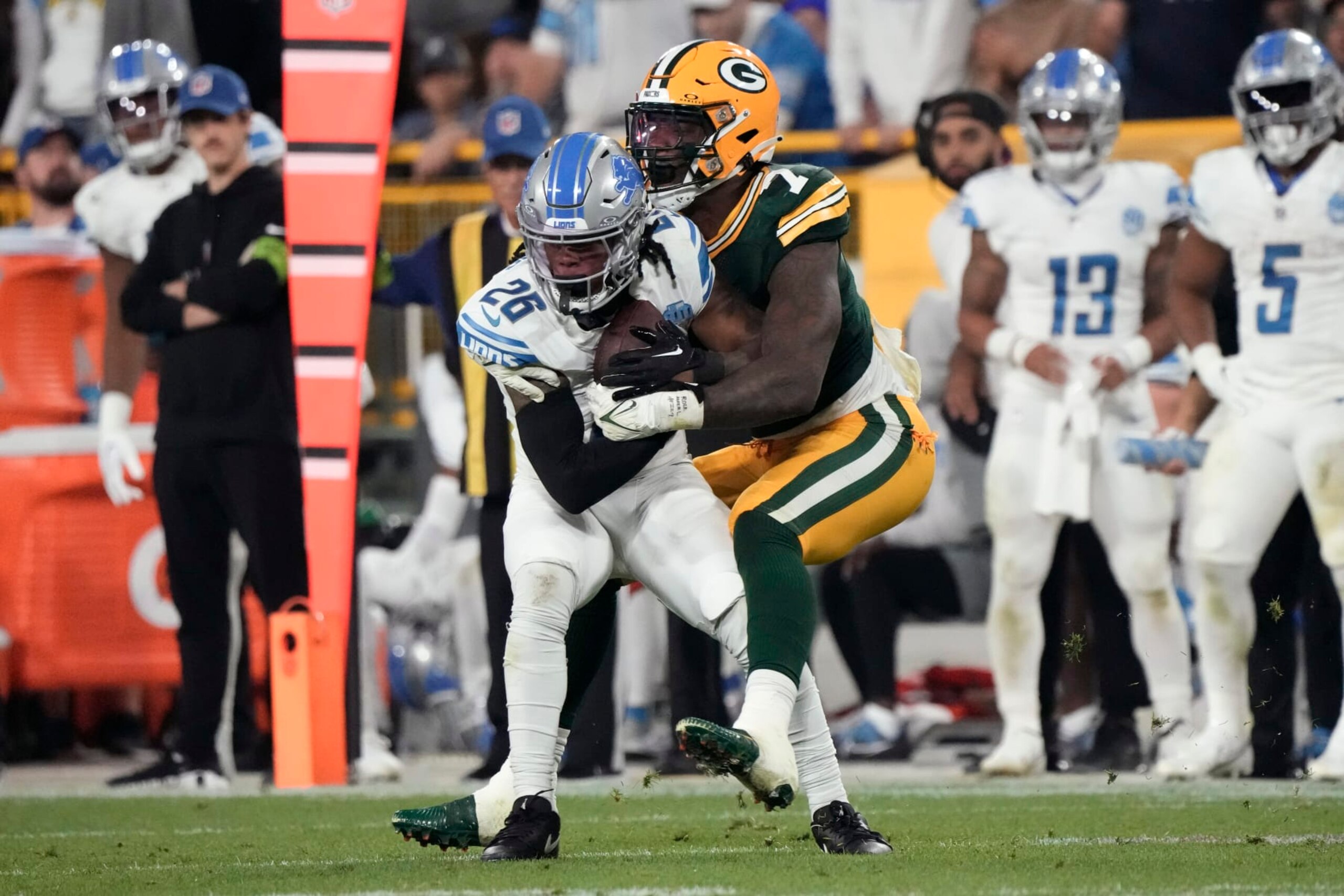 Detroit Lions running back Jahmyr Gibbs (26) is tackled by Green Bay Packers linebacker Quay Walker (7) after catching a pass during the second half of an NFL football game, Thursday, Sept. 28, 2023, in Green Bay, Wis. (AP Photo/Morry Gash)