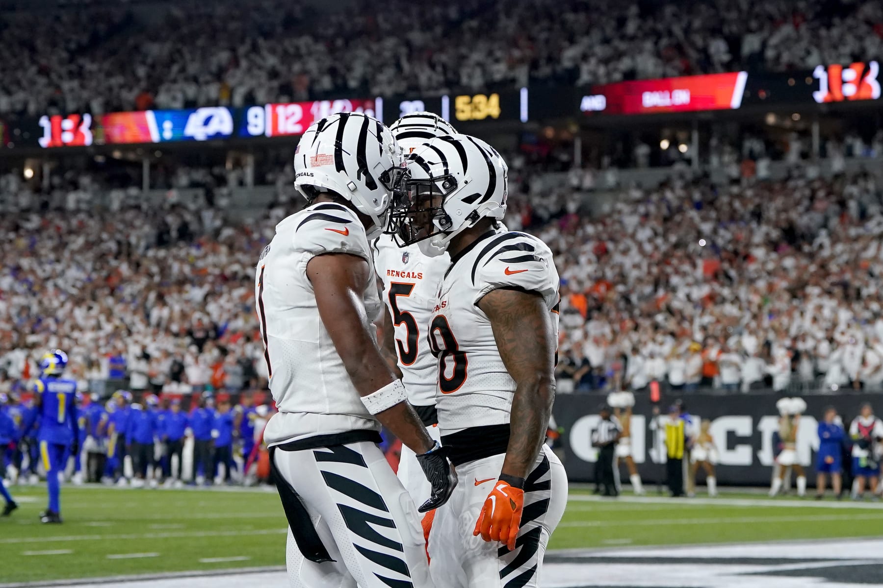 CINCINNATI, OHIO - SEPTEMBER 25: Joe Mixon #28 of the Cincinnati Bengals celebrates with Ja'Marr Chase #1 and Tee Higgins #5 after scoring a touchdown against the Los Angeles Rams during the third quarter in the game at Paycor Stadium on September 25, 2023 in Cincinnati, Ohio. (Photo by Dylan Buell/Getty Images)
