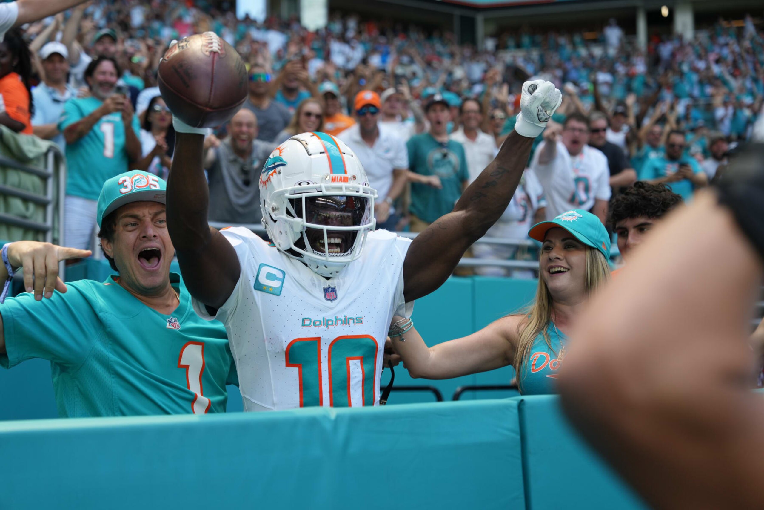 MIAMI GARDENS, FL - SEPTEMBER 24: Miami Dolphins wide receiver Tyreek Hill (10) celebrates with fans after jumping in to the stands after is touchdown reception in the first quarter during the game between the Denver Broncos and the Miami Dolphins on Sunday, September 24, 2023 at Hard Rock Stadium, Miami, Fla. (Photo by Peter Joneleit/Icon Sportswire via Getty Images)