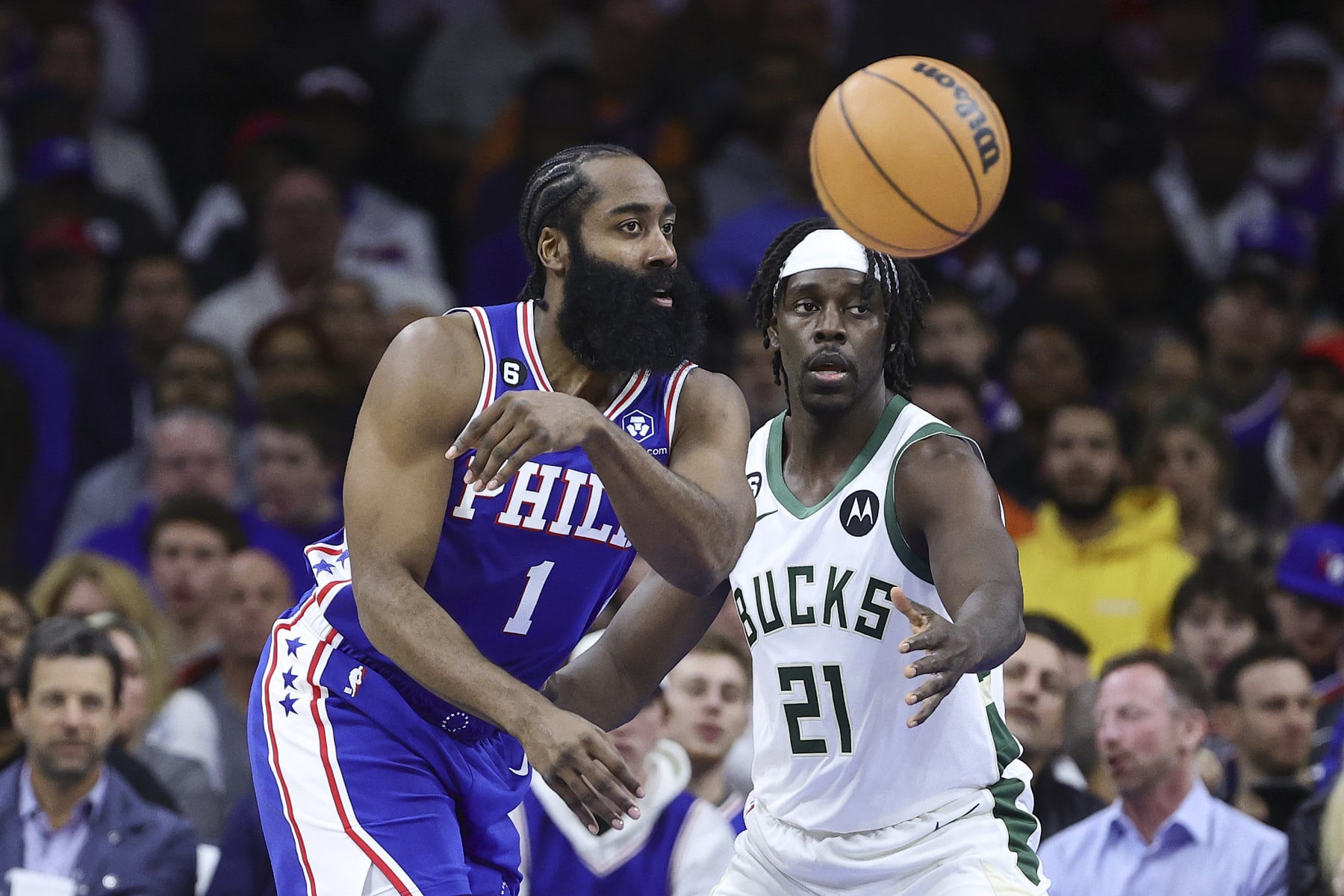 PHILADELPHIA, PENNSYLVANIA - OCTOBER 20: James Harden #1 of the Philadelphia 76ers passes past Jrue Holiday #21 of the Milwaukee Bucks during the second quarter at Wells Fargo Center on October 20, 2022 in Philadelphia, Pennsylvania. NOTE TO USER: User expressly acknowledges and agrees that, by downloading and or using this photograph, User is consenting to the terms and conditions of the Getty Images License Agreement. (Photo by Tim Nwachukwu/Getty Images)