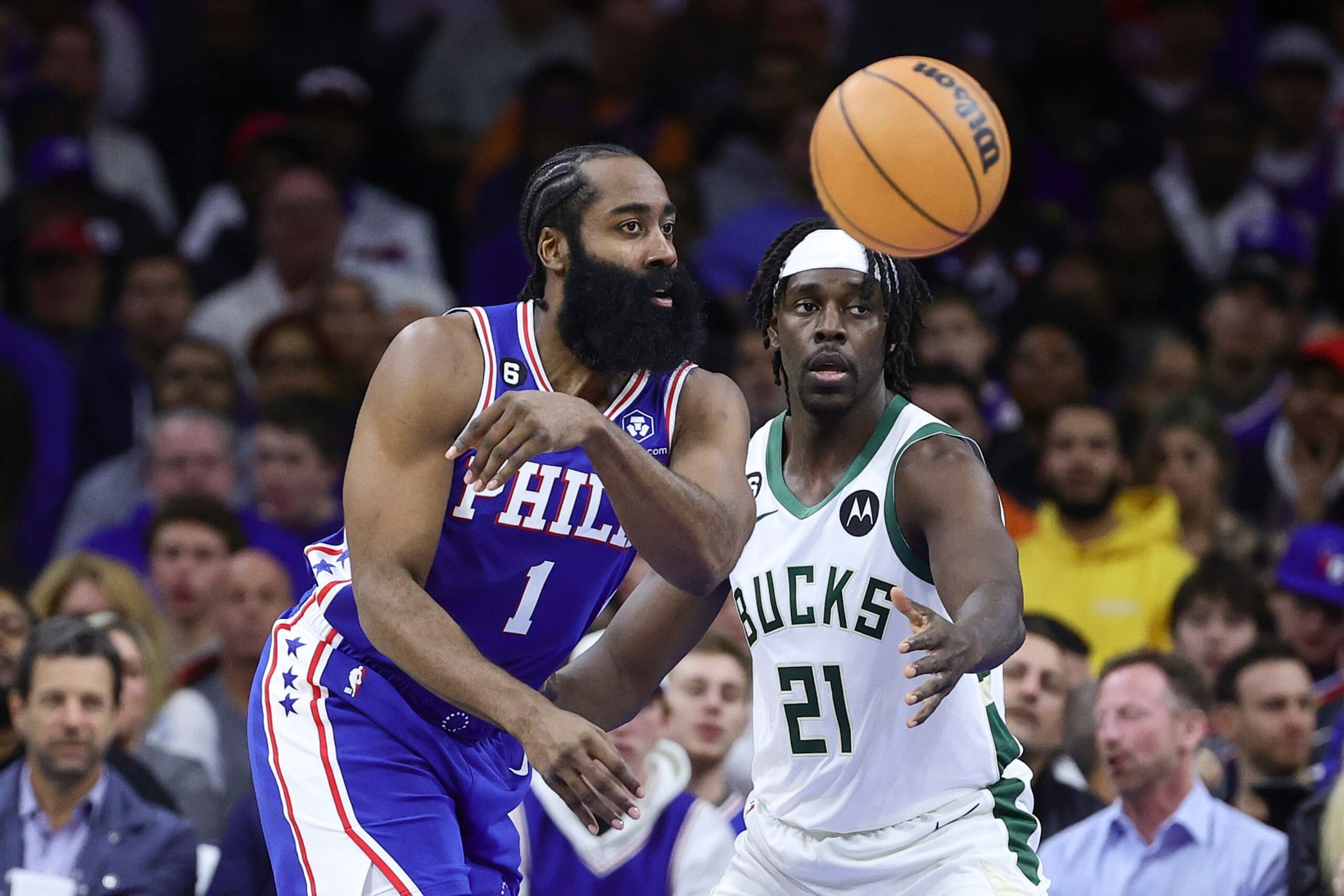 PHILADELPHIA, PENNSYLVANIA - OCTOBER 20: James Harden #1 of the Philadelphia 76ers passes past Jrue Holiday #21 of the Milwaukee Bucks during the second quarter at Wells Fargo Center on October 20, 2022 in Philadelphia, Pennsylvania. NOTE TO USER: User expressly acknowledges and agrees that, by downloading and or using this photograph, User is consenting to the terms and conditions of the Getty Images License Agreement. (Photo by Tim Nwachukwu/Getty Images)