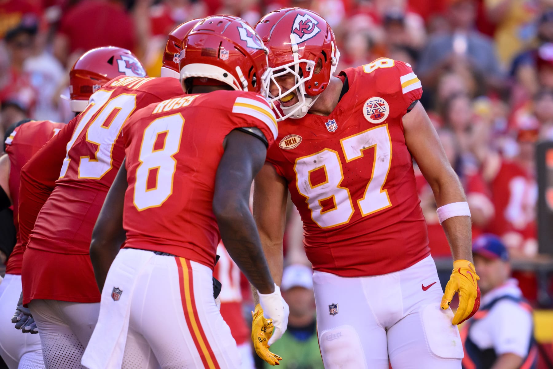 Kansas City Chiefs tight end Travis Kelce (87) celebrates his touchdown catch with Kansas City Chiefs wide receiver Justyn Ross (8) and Kansas City Chiefs offensive tackle Donovan Smith (79) during the second half of an NFL football game against the Chicago Bears, Sunday, Sept. 24, 2023 in Kansas City, Mo. (AP Photo/Reed Hoffmann)