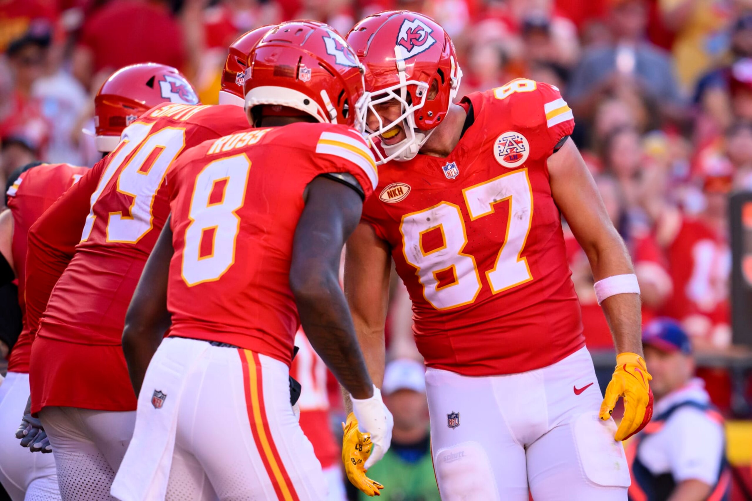 Kansas City Chiefs tight end Travis Kelce (87) celebrates his touchdown catch with Kansas City Chiefs wide receiver Justyn Ross (8) and Kansas City Chiefs offensive tackle Donovan Smith (79) during the second half of an NFL football game against the Chicago Bears, Sunday, Sept. 24, 2023 in Kansas City, Mo. (AP Photo/Reed Hoffmann)