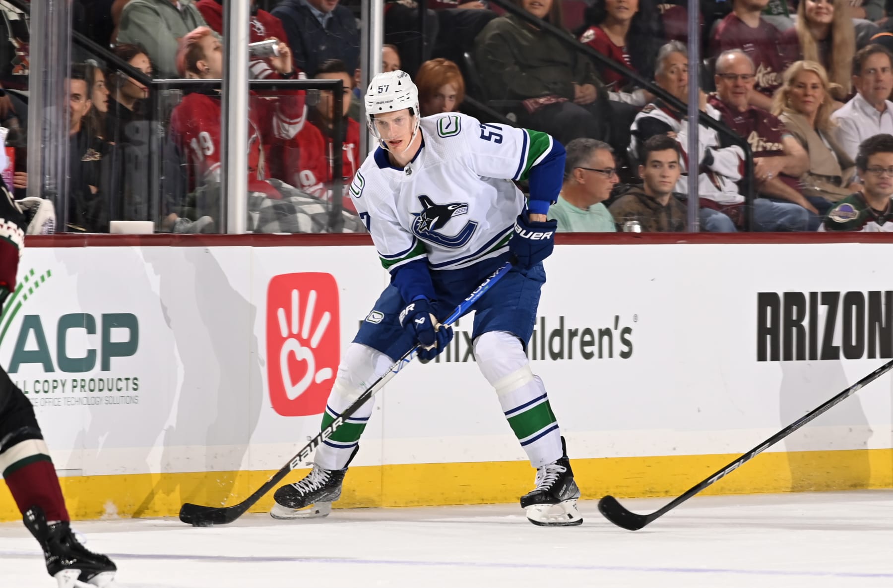 TEMPE, ARIZONA - APRIL 13: Tyler Myer #57 of the Vancouver Canucks skates with the puck against the Arizona Coyotes at Mullett Arena on April 13, 2023 in Tempe, Arizona. (Photo by Norm Hall/NHLI via Getty Images)