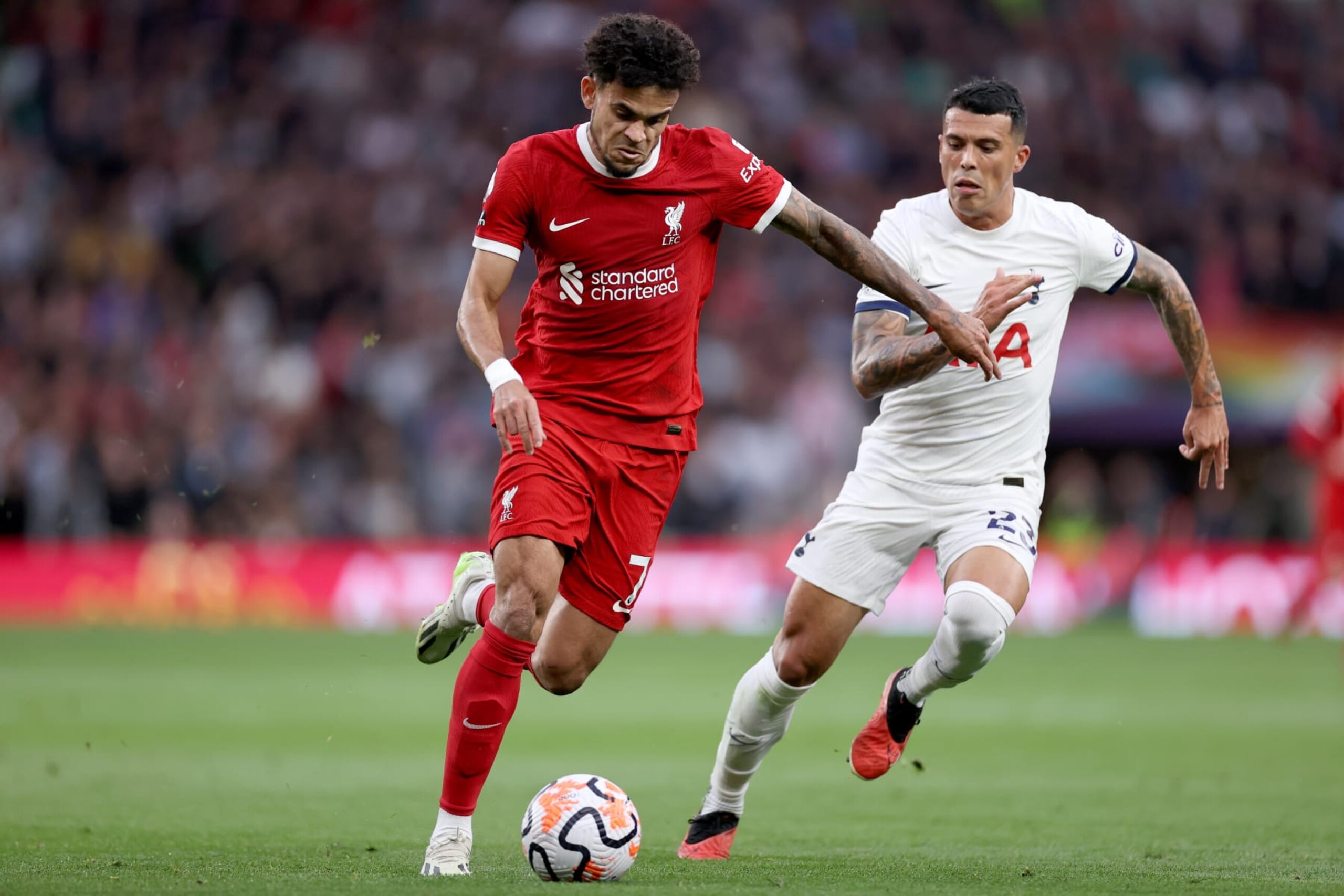 LONDON, ENGLAND - SEPTEMBER 30: Luis Diaz of Liverpool runs with the ball whilst under pressure from Pedro Porro of Tottenham Hotspur  during the Premier League match between Tottenham Hotspur and Liverpool FC at Tottenham Hotspur Stadium on September 30, 2023 in London, England. (Photo by Ryan Pierse/Getty Images)
