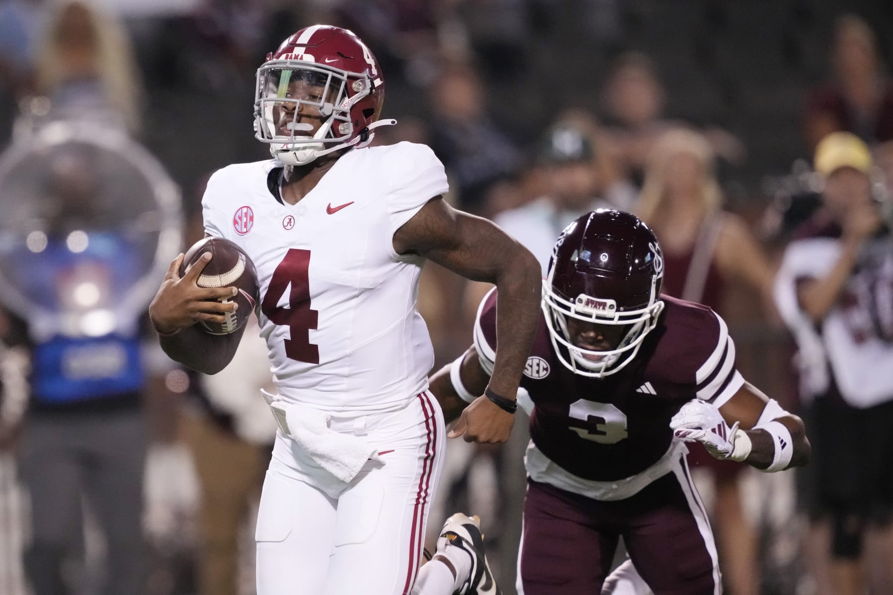 Alabama quarterback Jalen Milroe (4) scrambles for a touchdown run past Mississippi State cornerback Decamerion Richardson (3) during the first half of an NCAA college football game, Saturday, Sept. 30, 2023, in Starkville, Miss. (AP Photo/Rogelio V. Solis)