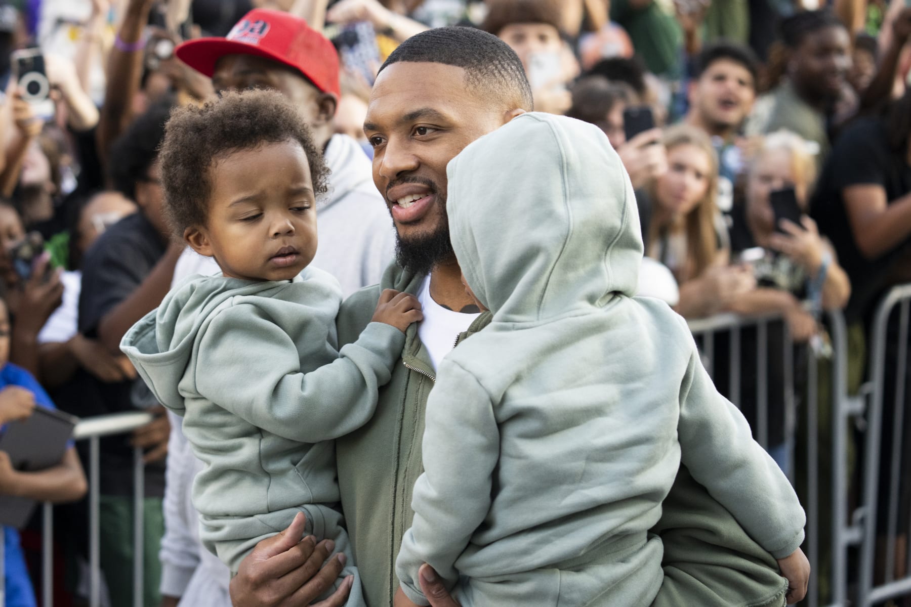 MILWAUKEE, WISCONSIN - SEPTEMBER 30: Damian Lillard walks with his kids during a welcome rally at Fiserv Forum on September 30, 2023 in Milwaukee, Wisconsin. NOTE TO USER: User expressly acknowledges and agrees that, by downloading and or using this photograph, User is consenting to the terms and conditions of the Getty Images License Agreement.(Photo by Patrick McDermott/Getty Images)